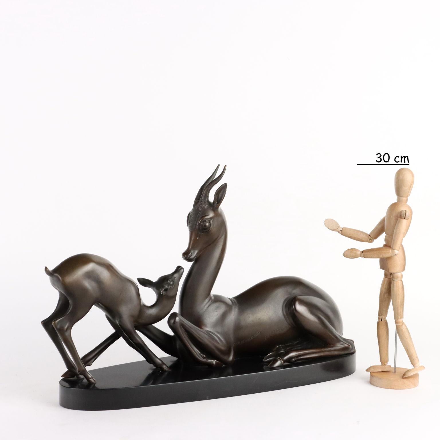 Bronze sculpture depicting a pair of fawns on a black marble base. Author's signature engraved on the side of the base.