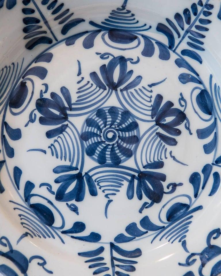 We are pleased to offer this exceptional 18th century Delft charger painted in a crisp, bold, geometric pattern. Made in England circa 1760, this energetic Blue and White design indicates that the charger was likely made in the Lambeth High Street