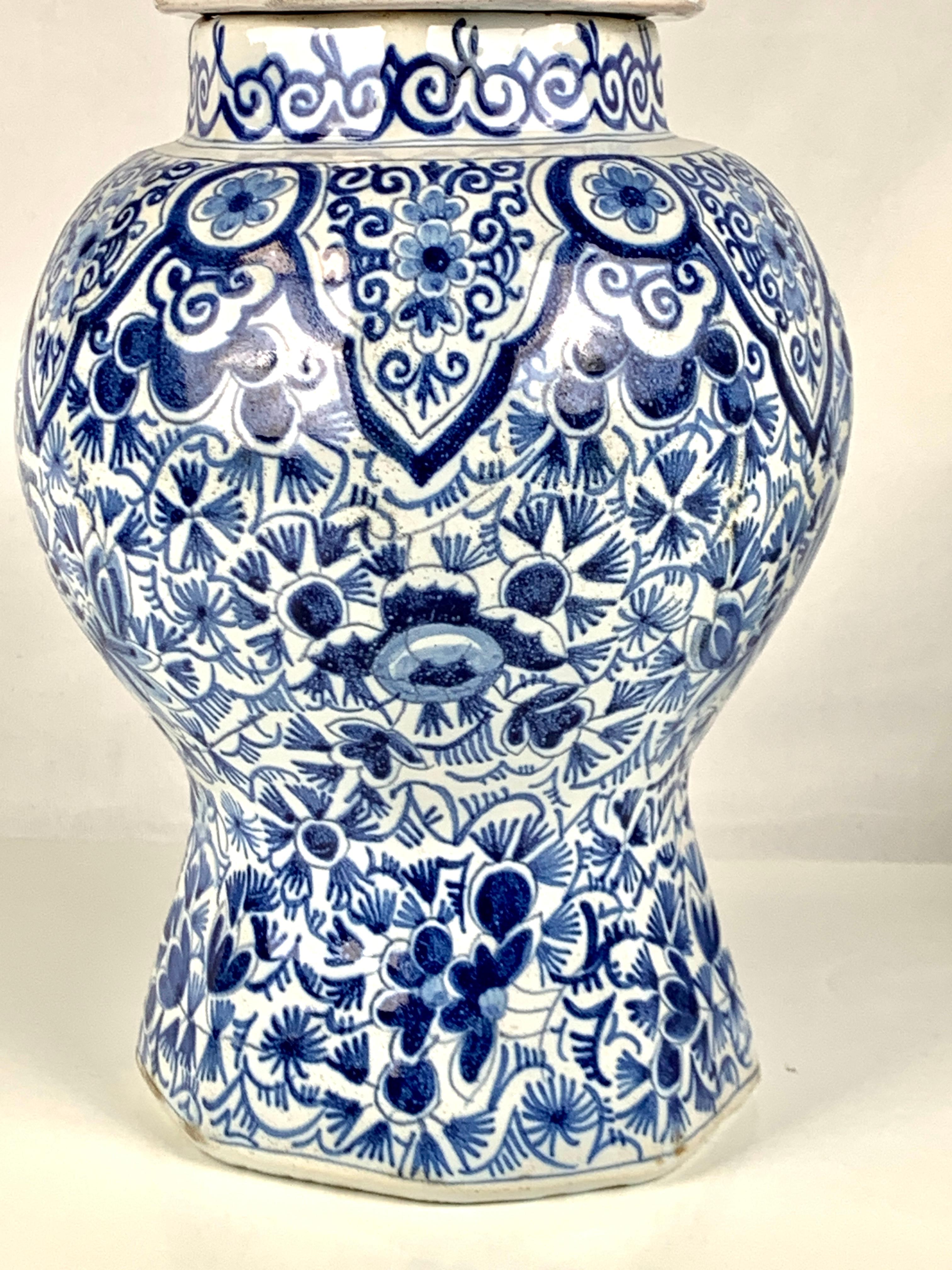 This hand-painted jar and cover from circa 1790 boasts beautiful Dutch Delft floral artwork. 
The intricate design features a stunning array of blooms and vines in deep and medium cobalt blue. 
The shoulders of the jar are adorned with lappets