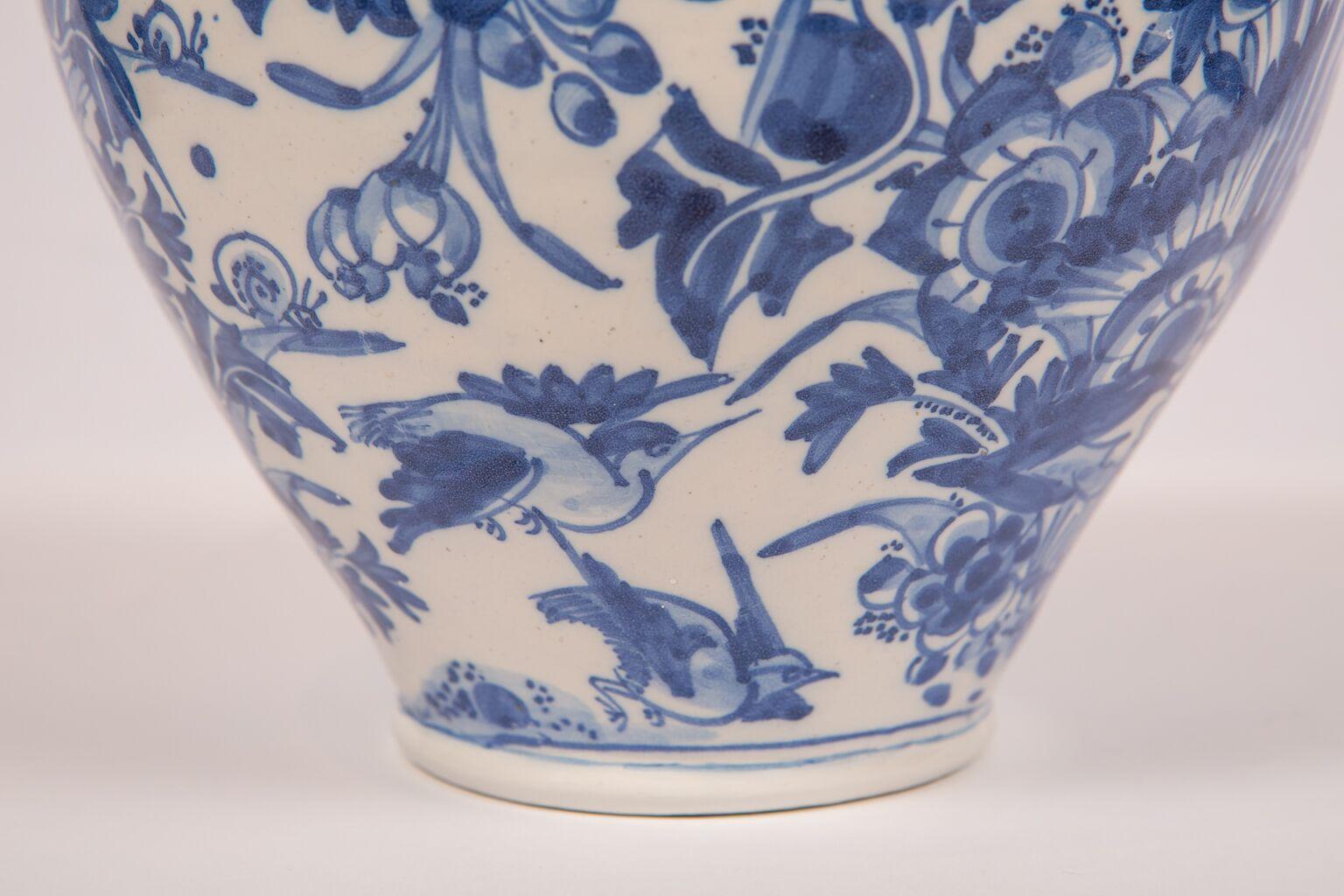 WHY WE LOVE IT:  It's 17th century-pastel blue, and well painted
 Decorated with birds, butterflies, and wonderful flowers. The high quality, freehand painting style and pastel blue palette on this baluster form London Delft vase became the