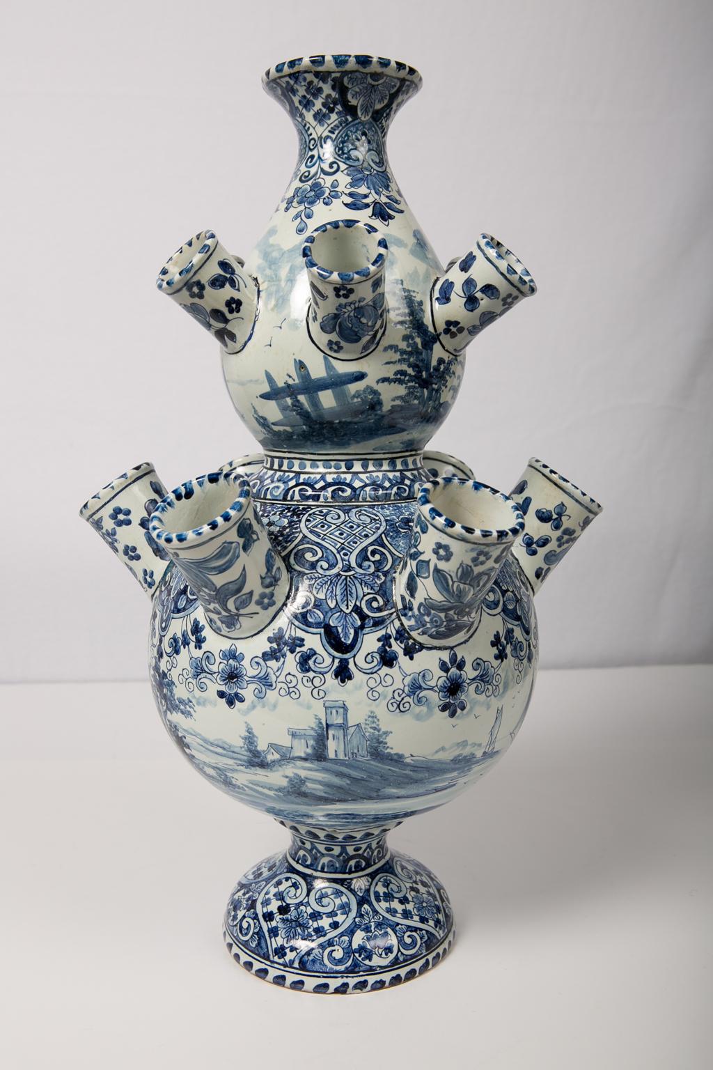 Antique Dutch delft large blue and white tulipiere (tulip holder) in a double gourd shape with 12 spouts for tulips, and an opening at the top for water. The circular body is decorated in cobalt blue featuring traditional scenes of sailboats and a