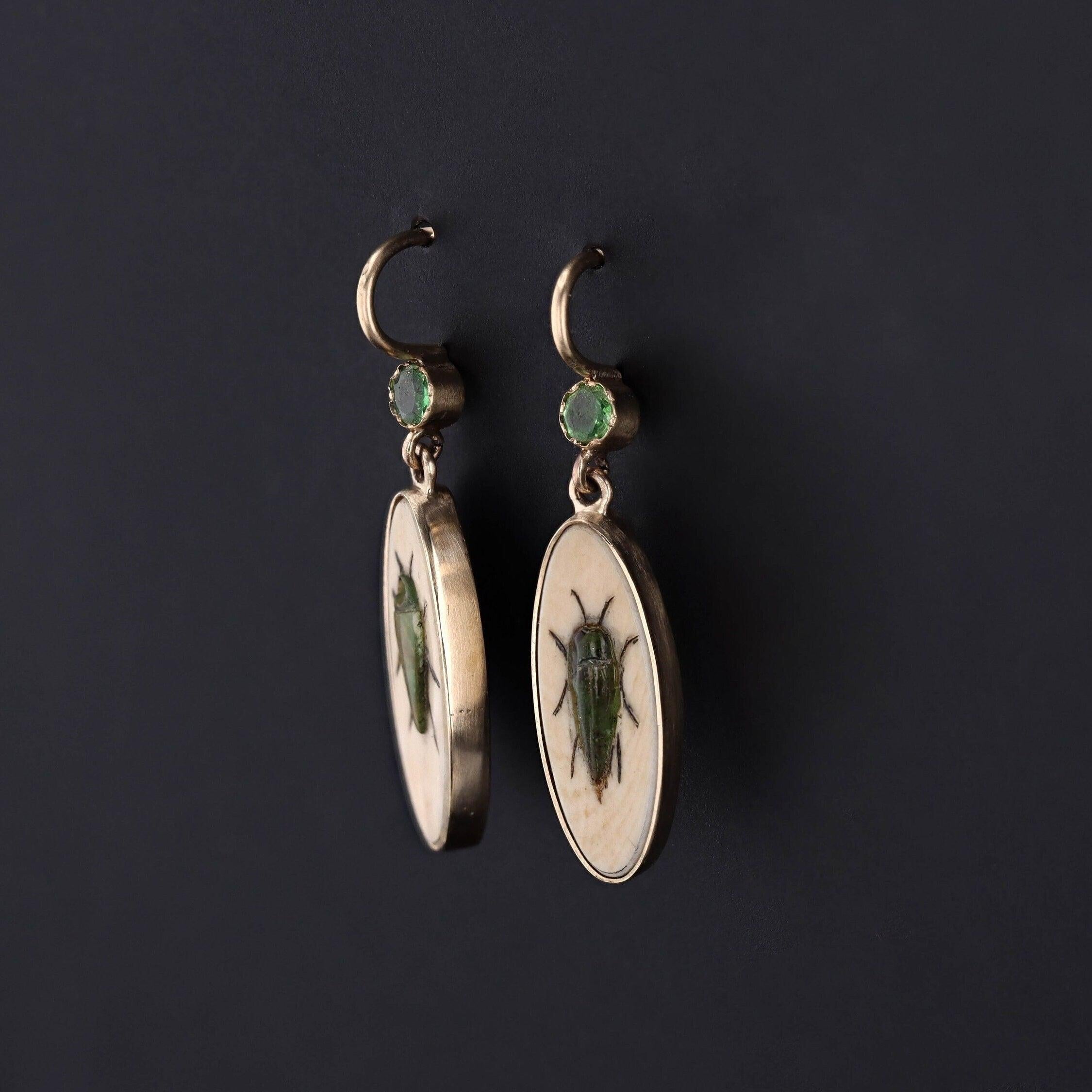 To create these earrings, our jeweler carefully cut antique shibayama game pieces (circa 1880) into an oval shape, mounted them in 14k gold, and added 14k ear wires and demantoid garnet surmounts. 

Each earring measures 1.1 inches from the top of