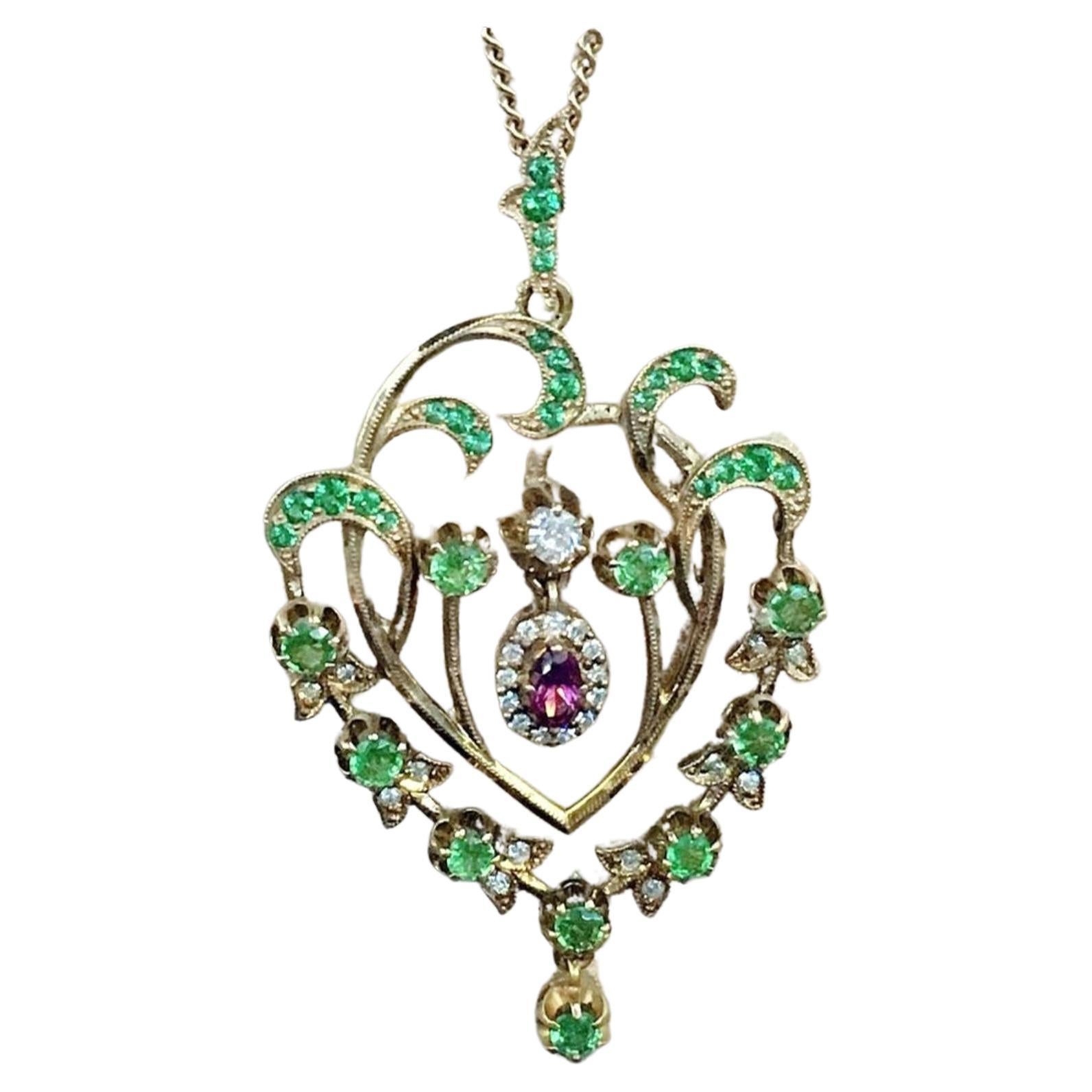 Antique large Russian natural green Demantoid garnet in artnovo style pendant centered with dangling tourmalin stone flanked with old cut diamonds H color white in 14k gold setting hall marked 56 imperial russian gold standard pendant dates back to