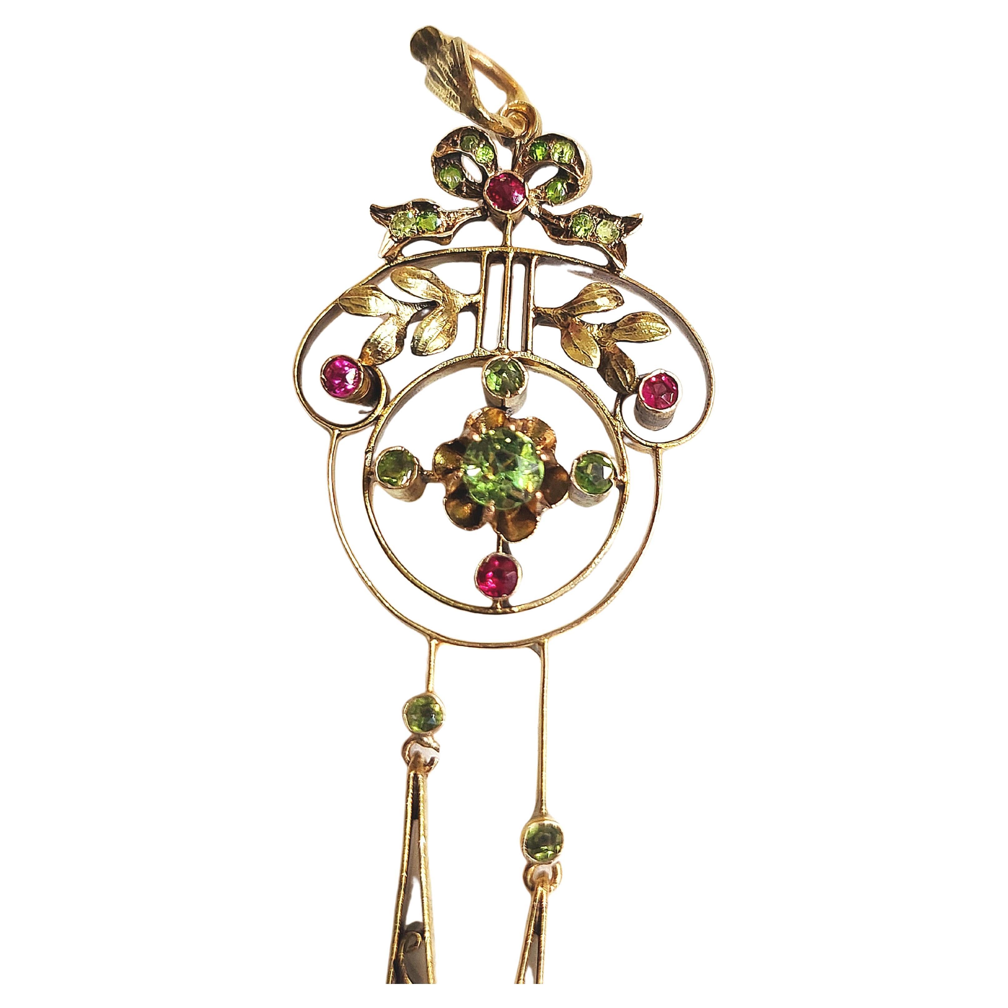 Antique imperial russian era pendant in artnoveu style decorted with green demantoied and ruby in 14k gold setting pendant lenght 7cm hall marked 56 imperial russian gold standard and moscow assay mark 1907/1910s