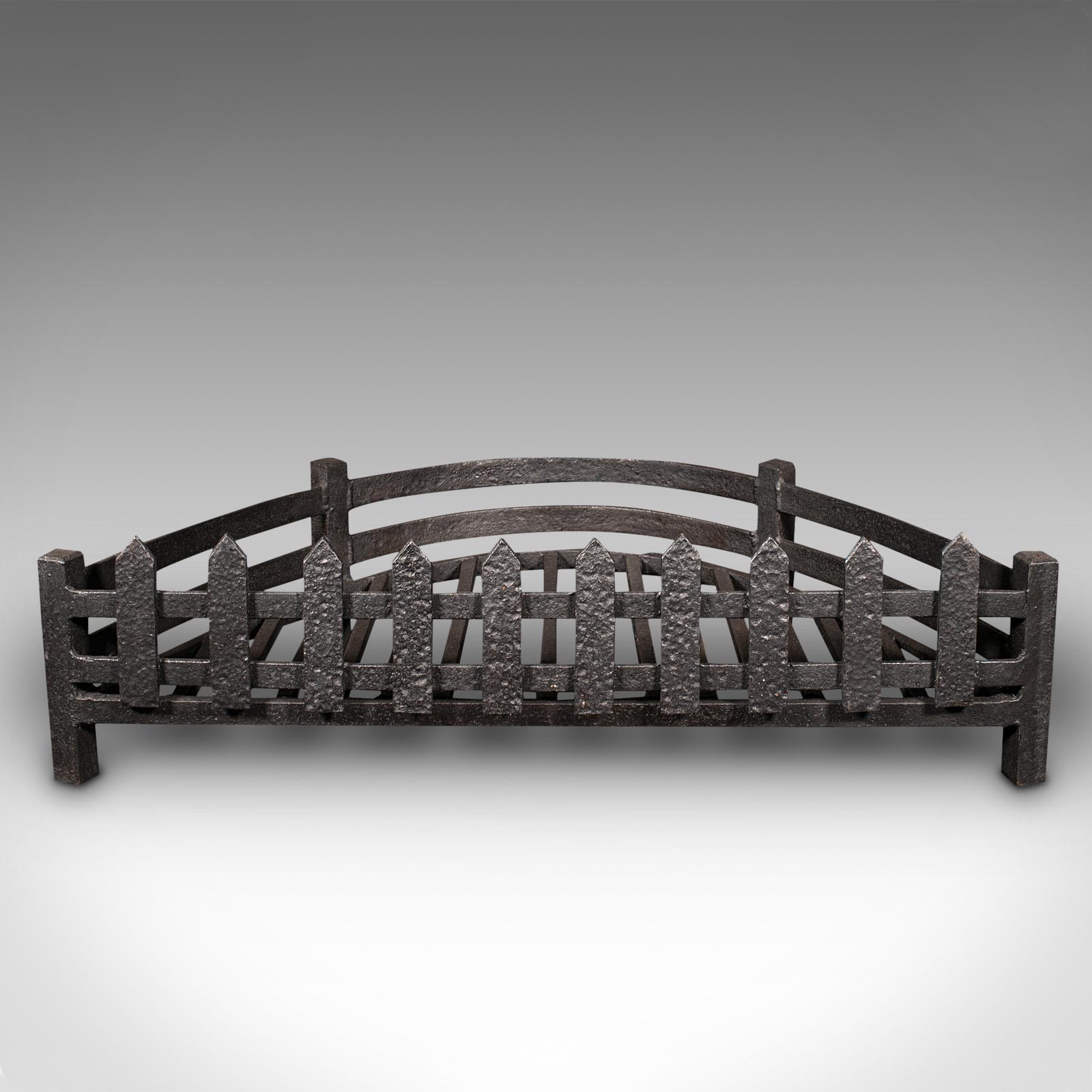 This is an antique demi-lune fire grate. An English, cast iron fireplace basket, dating to the late Victorian period, circa 1900.

Delightfully unusual shape, with appealing weathered finish
Displays a desirable aged patina throughout
Patinated