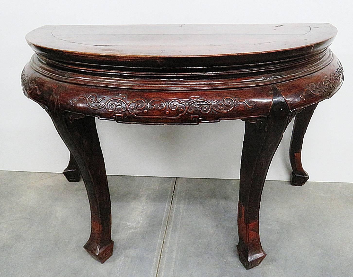 Antique demilune carved hall table.