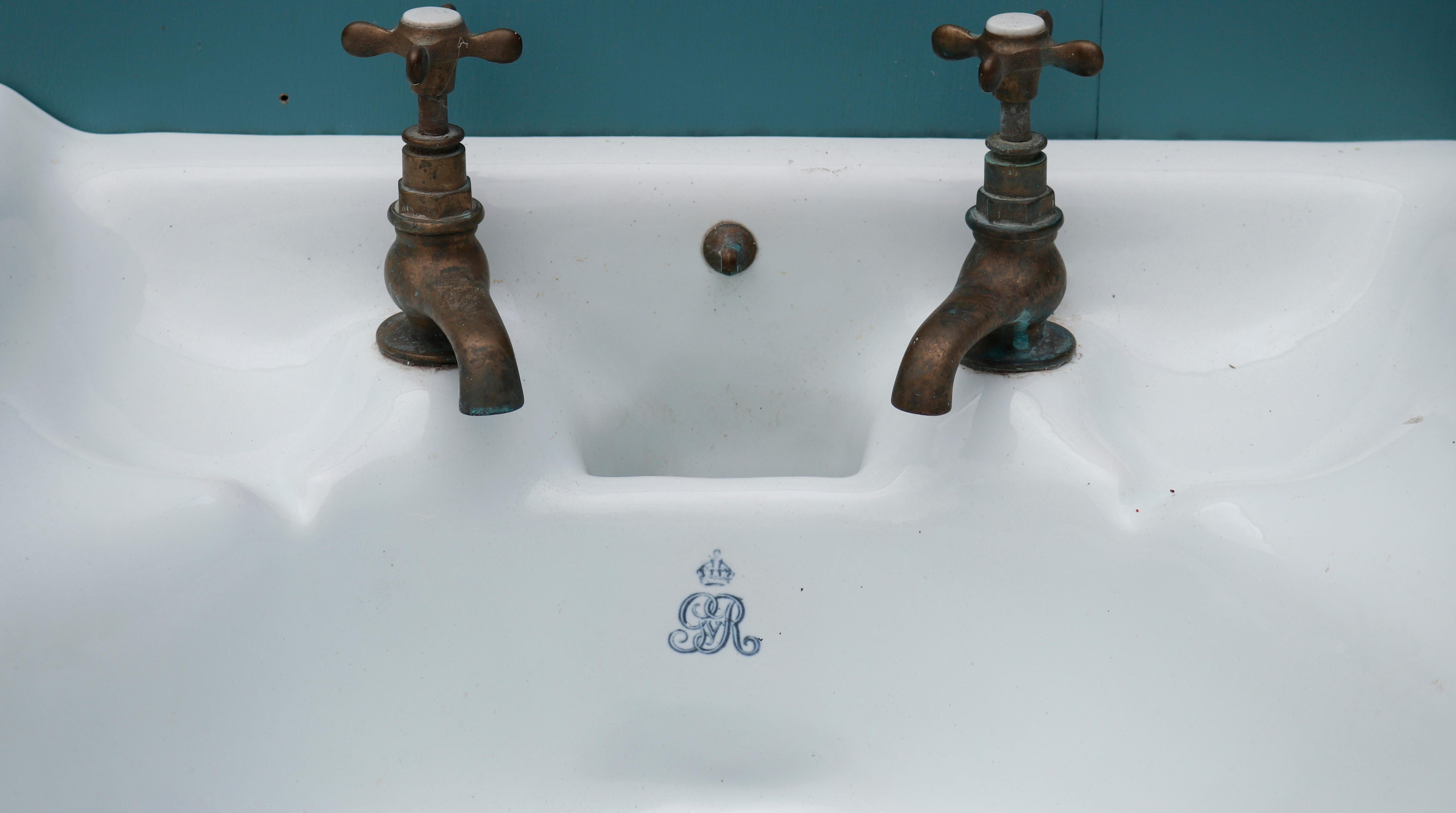 A double sink manufactured by Dent and Hellyer Ltd. based in 35 Red Lion Square, London.

The basins are stamped with the monogram of King George V, suggesting they were removed from a government building. Supplied with a modern steel stand.