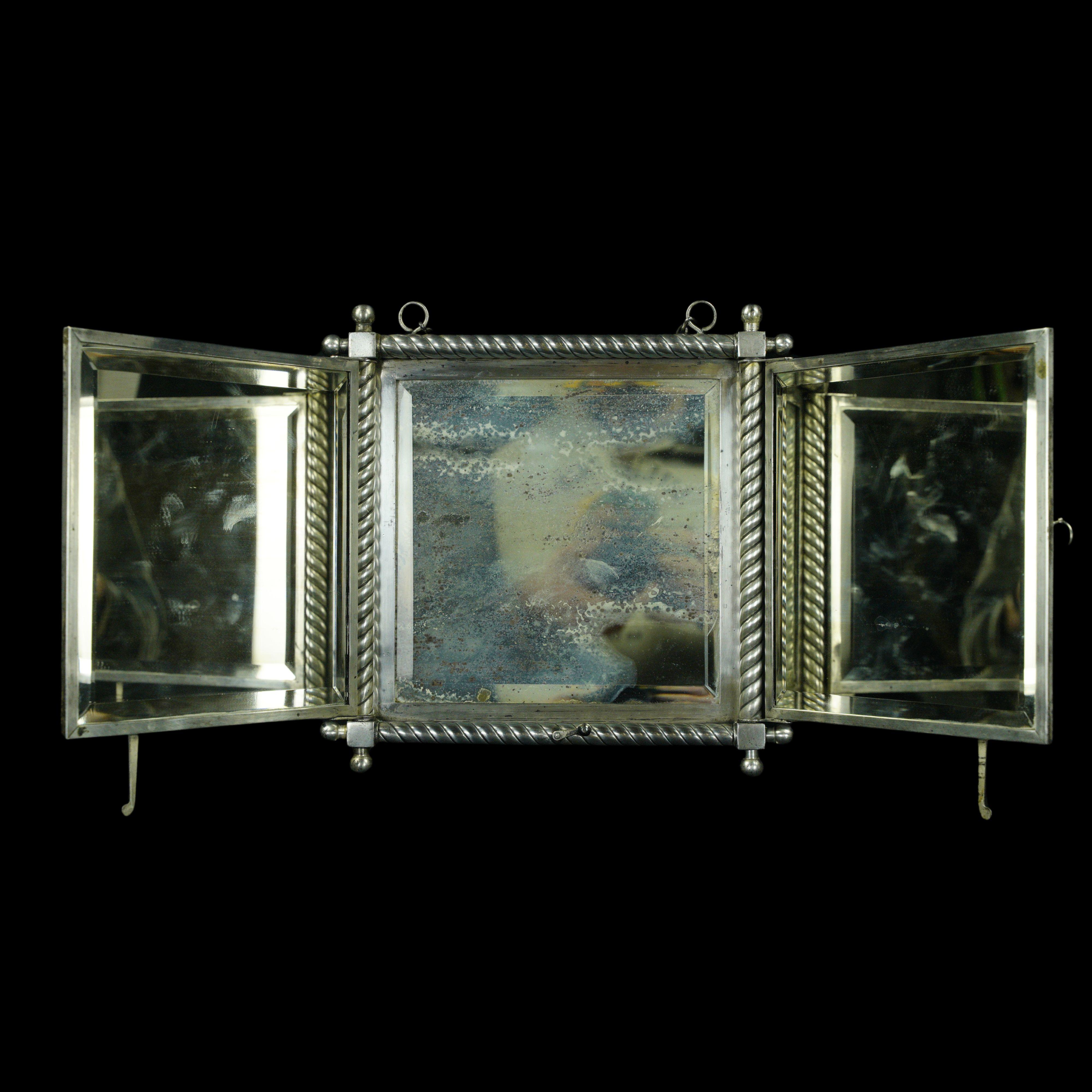 Quadruple silvered tri-fold beveled shaving mirror with decorative details. Stamped Derby Silver. Quadruple plated. P. Wiederer's Patent April 19, 1887. 7 E. Good condition with appropriate wear from age, with minor scratches and tarnish. One