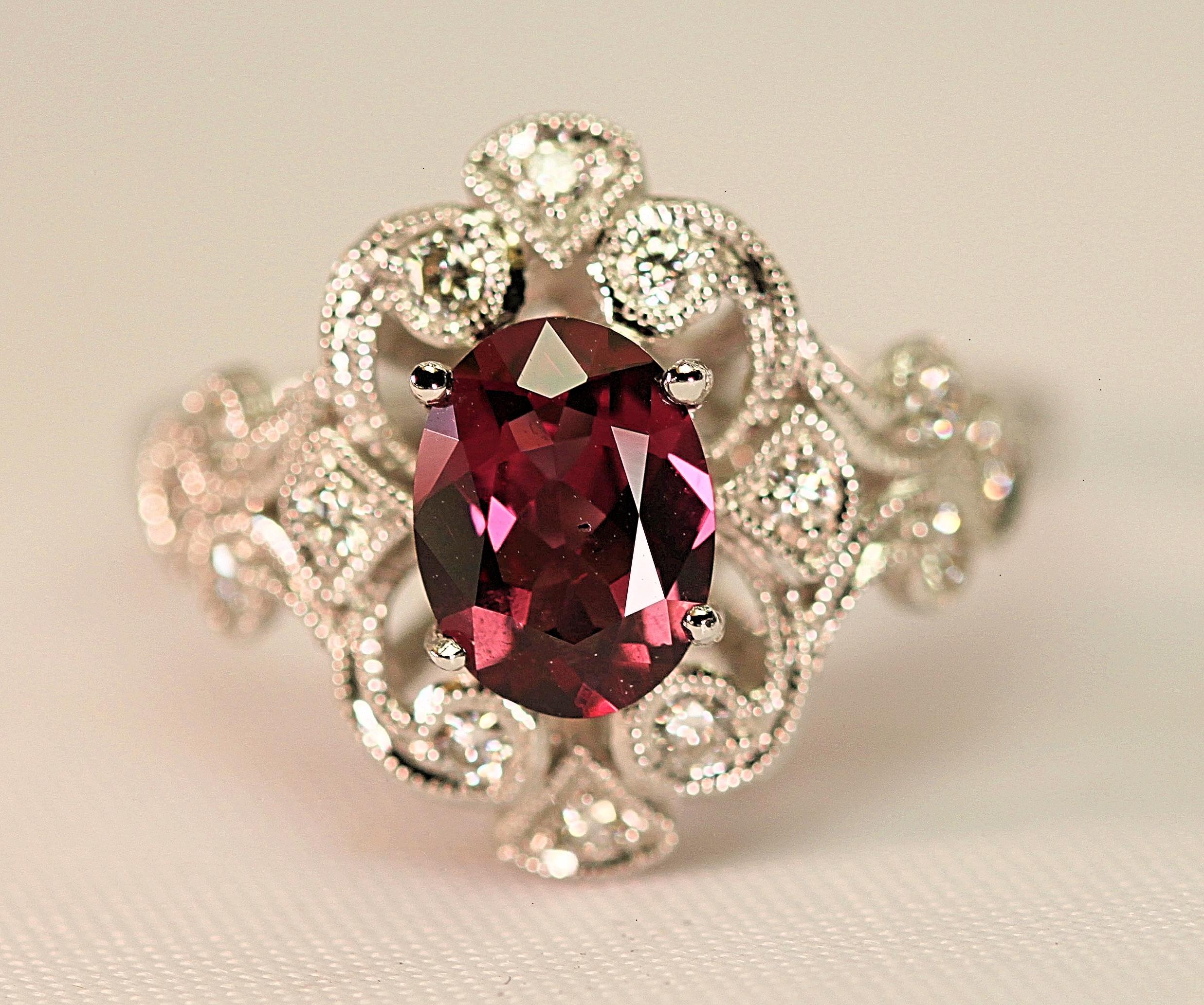 The garnet and diamond ring has been well constructed using a beautiful rhodolite garnet that weighs approximate 1.40 carats total and accent diamonds that weight an approximate .26 carat total.  The  garnet is a lively purple/pink stone and the