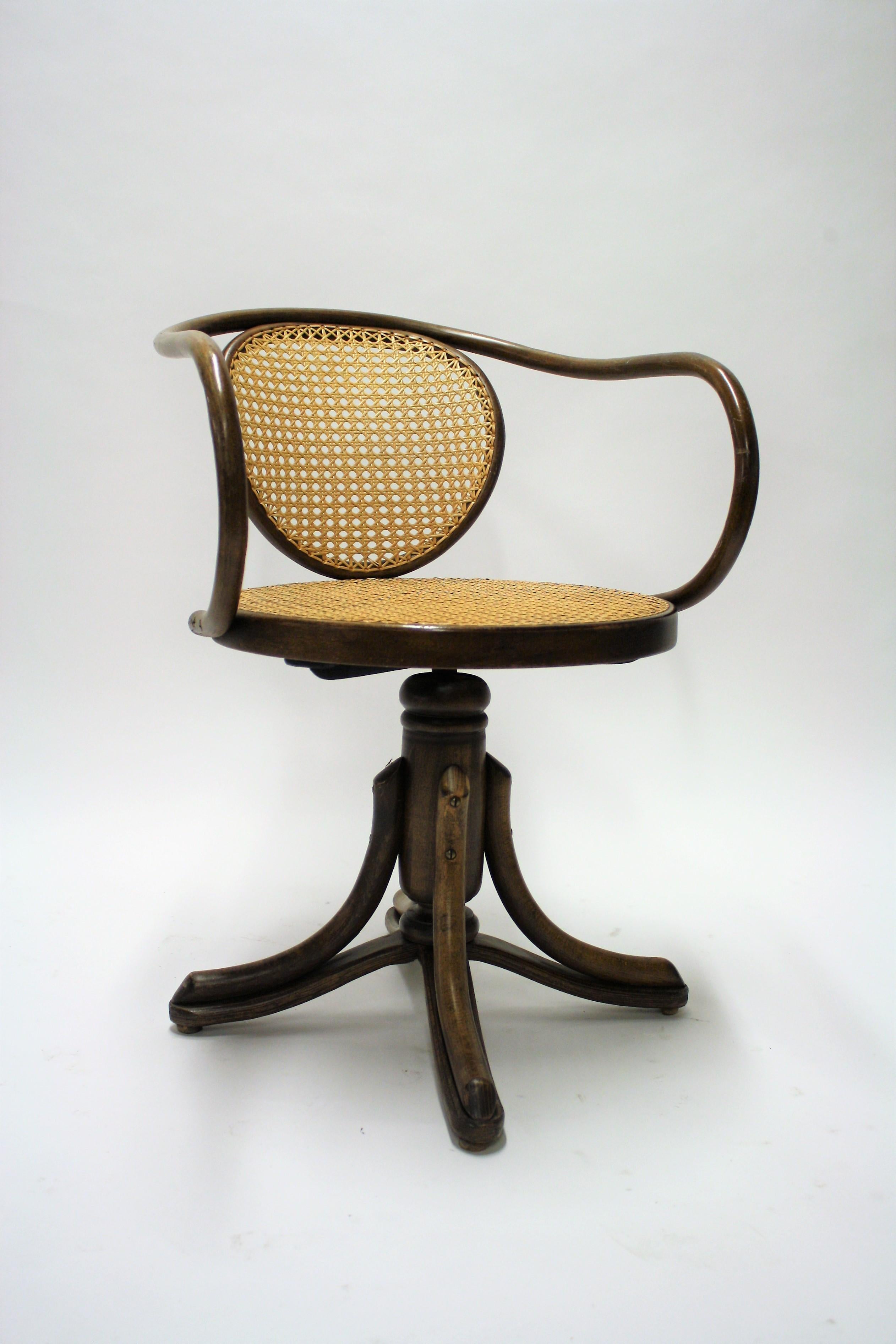 Late 19th-early 20th century bentwood and rattan desk chair designed by Thinef for ZPR Daomsko.

Model 5501.

This swivel chair is adjustable in height by turning it.

Thonet was one of the first company using the steam bending technique for