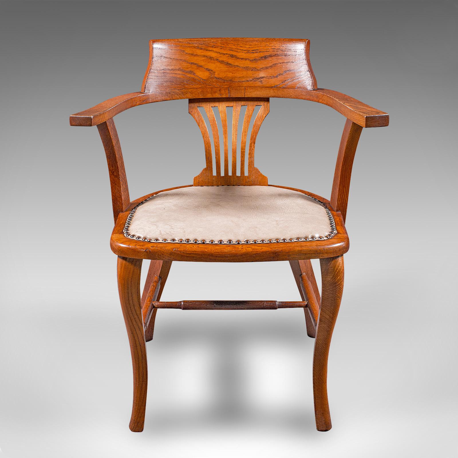
This is an antique desk elbow chair. An English, oak office seat, dating to the Edwardian period, circa 1910.

Appealing elbow chair, ideal for the drawing room or home office
Displays a desirable aged patina and in good order throughout
Select oak