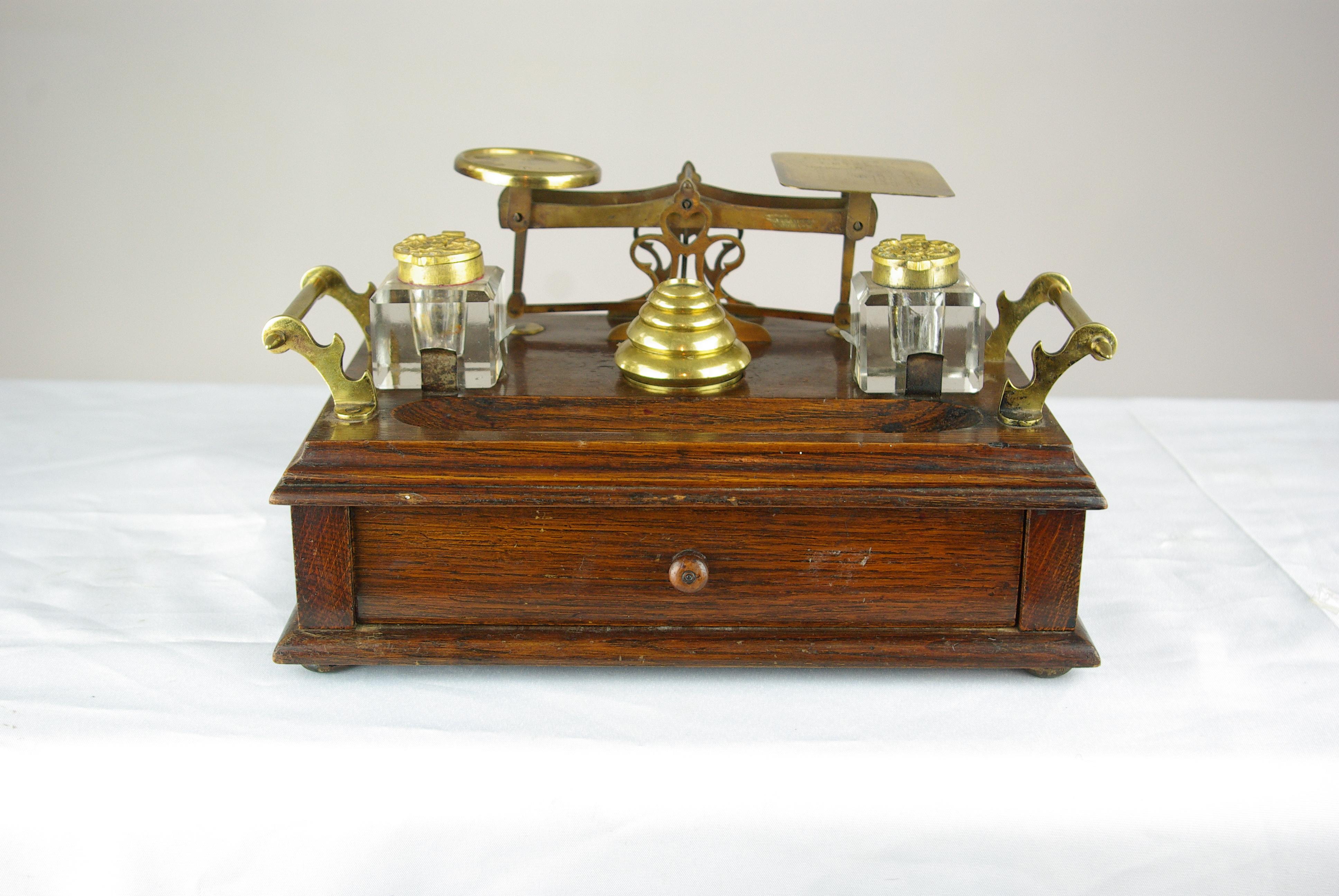Antique desk set, Scottish Victorian inkstand, postal scale, and weights, very rare, B1430C

Scotland, 1870s
All original
Oak wooden stand with brass handles to lock side
Brass scales at the back with wonderful engraving on the