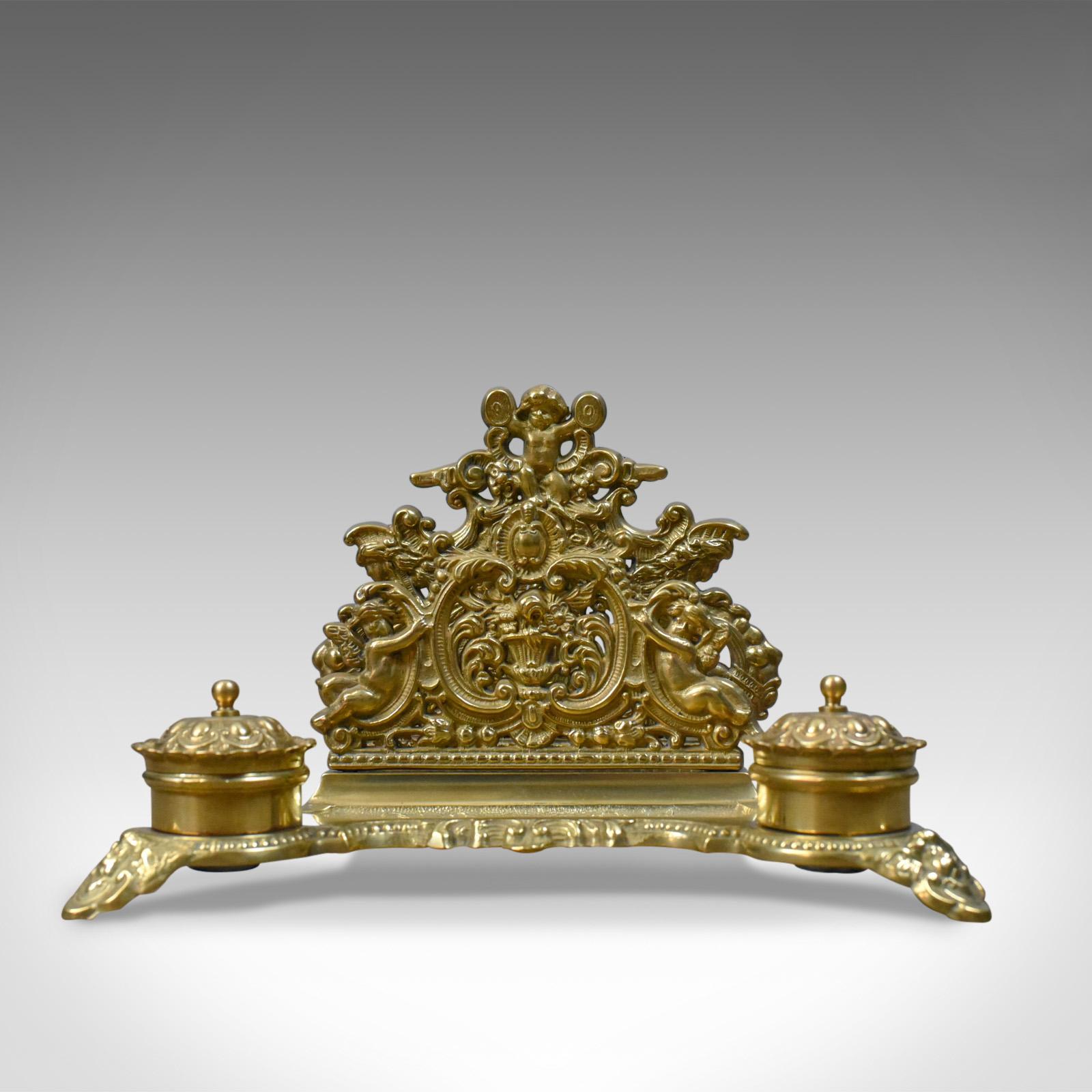 This is an antique desk stand, an English, Edwardian gilt metal letter rack with inkwells dating to circa 1910.

Impressive Edwardian desk stand in gilt metal
Profusely decorated with scroll, floral and foliate detail
The letter rack formed by a