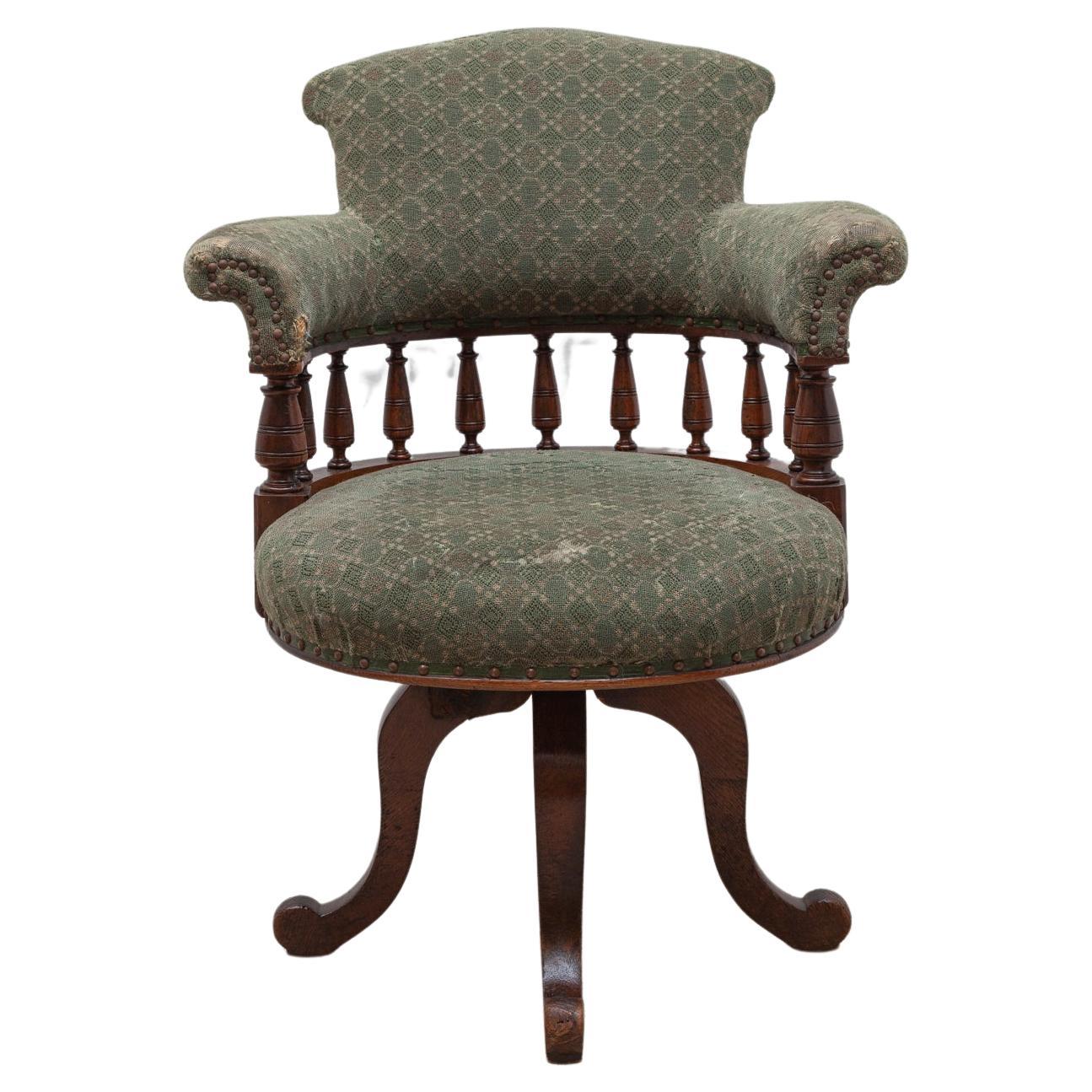 Beautiful traditional shipping era swivel Chippendale desk chair. The Captain's Chair, with the modern addition of a turn and tilt mechanism. The comfortable desk chair is in its original good condition, the upholstery shows places of intensive use,