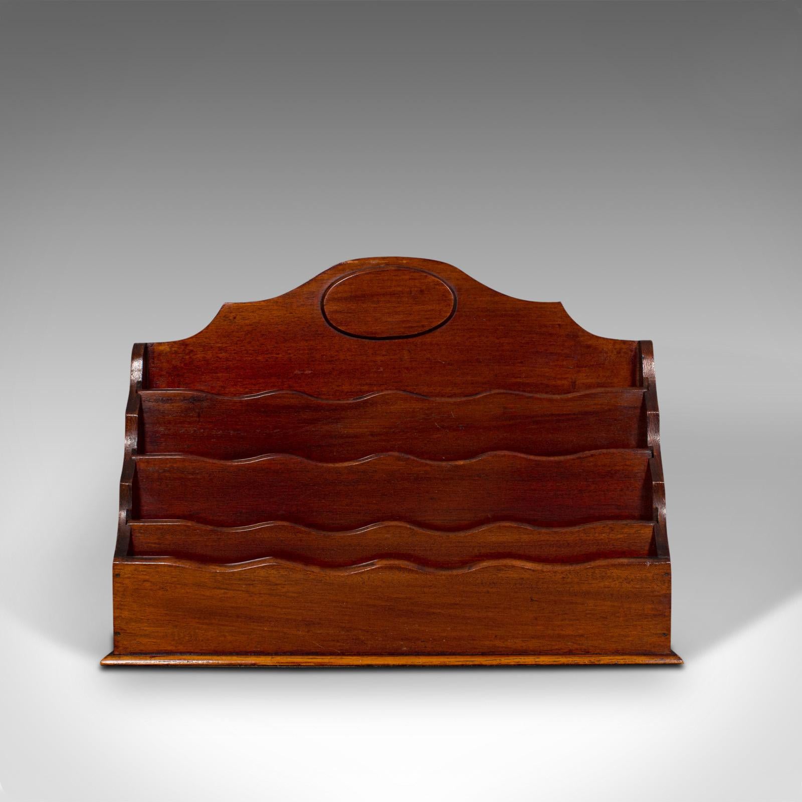 This is an antique desk tidy. An English, mahogany letter or stationery rack, dating to the Edwardian period, circa 1910.

Attractive wavy form draws the eye
Displaying a desirable aged patina
Select mahogany shows fine grain interest
Rich
