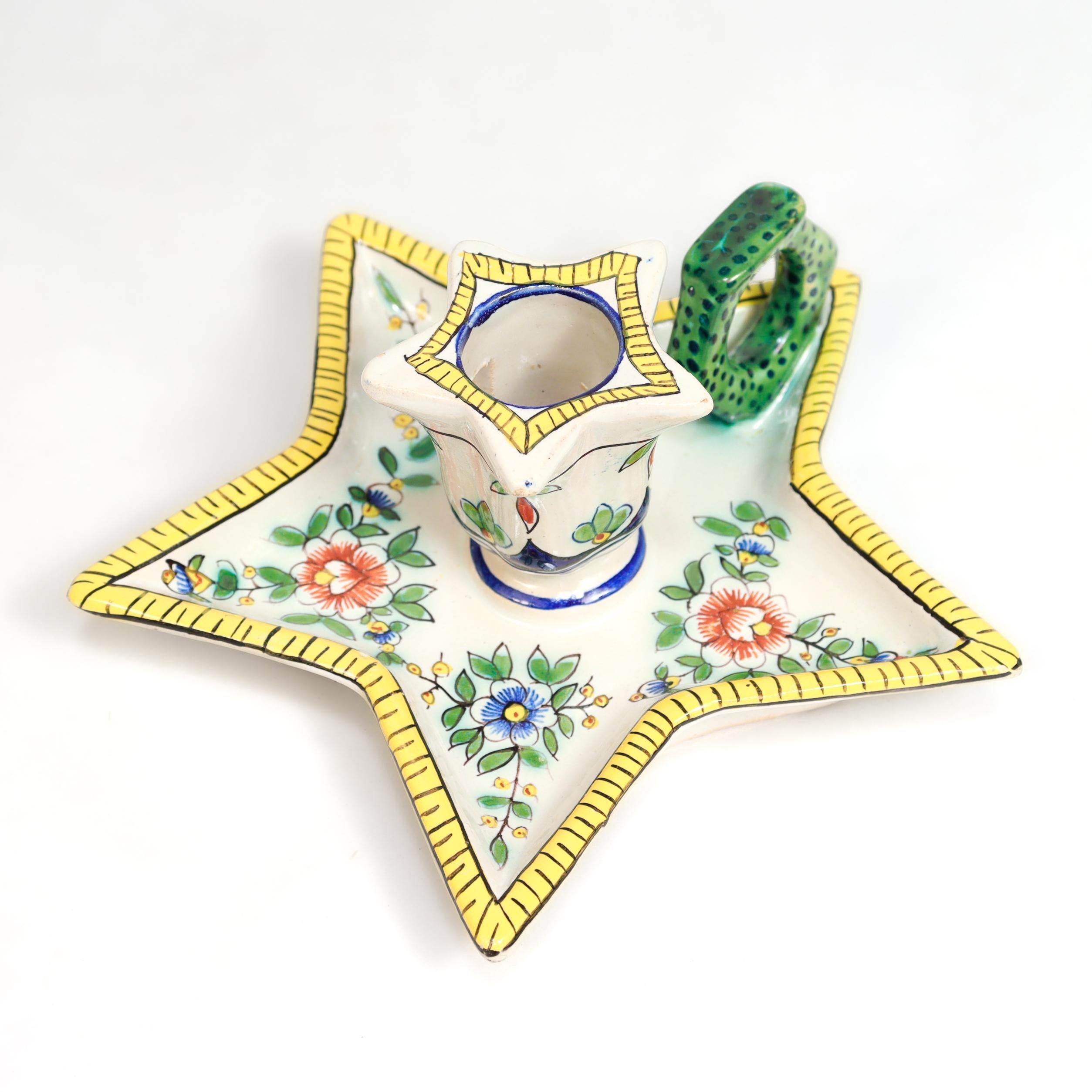 A fine antique French faïence chamberstick candle holder.

By Charles-François Fourmaintraux-Courquin.

The star shaped candle holder and under plate decorated in yellow, green, blue, and red underglaze decoration on a white ground.

Marked to the