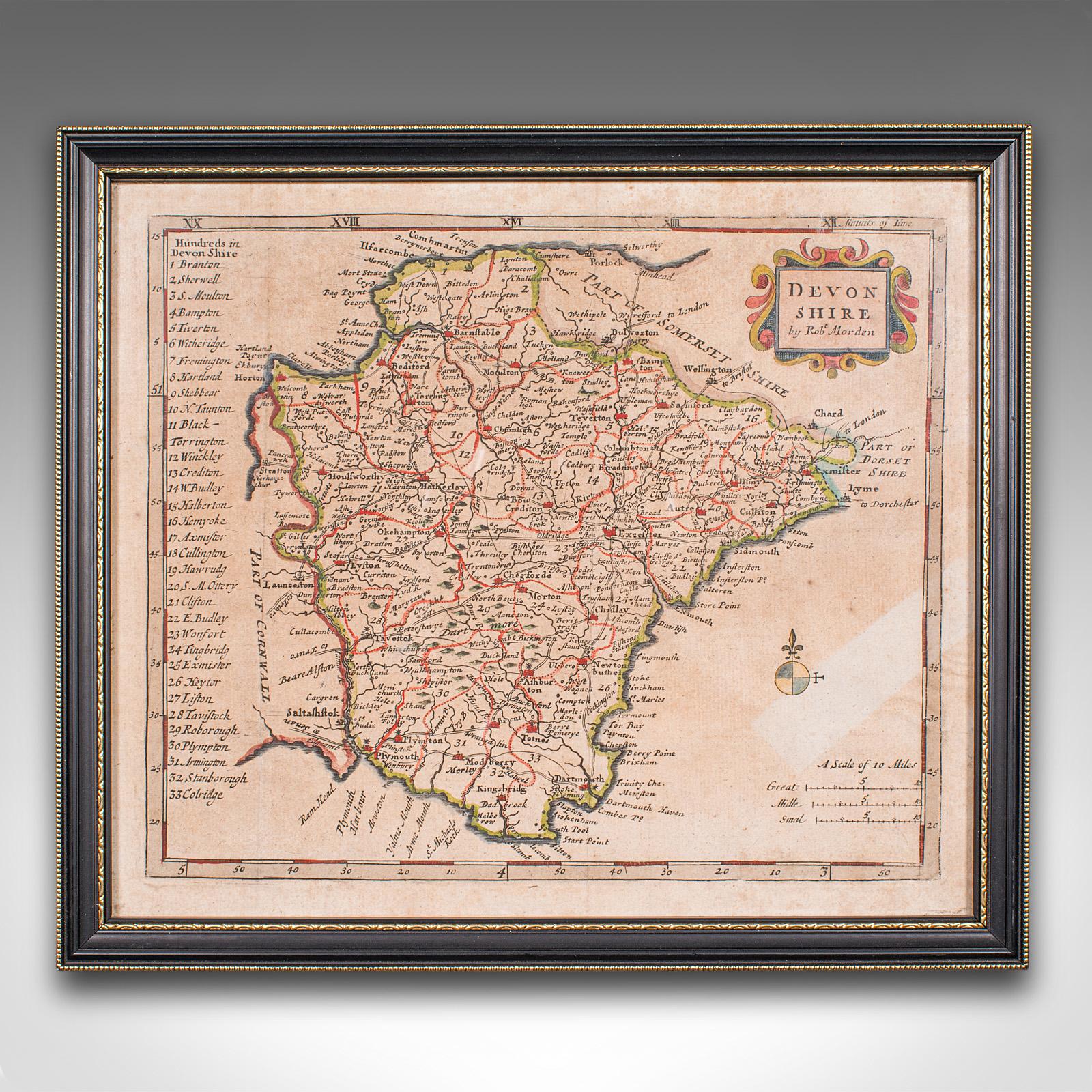 Questa è una piccola mappa antica del Devonshire, un'incisione cartografica inglese incorniciata di Robert Morden, risalente al primo periodo georgiano, circa 1720. Questa incisione colorata a mano, che rappresenta una rappresentazione affascinante
