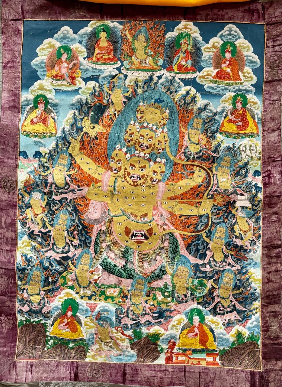 Dated from the 1920s, painted paper on silk brocade. This Thangka depicts Dharmpala, one of the three ancient treasure protectors of Buddhist teaching, this one being named Rahula. It's lineage is from the Nyugna school of Tibetan buddhism. Rahula