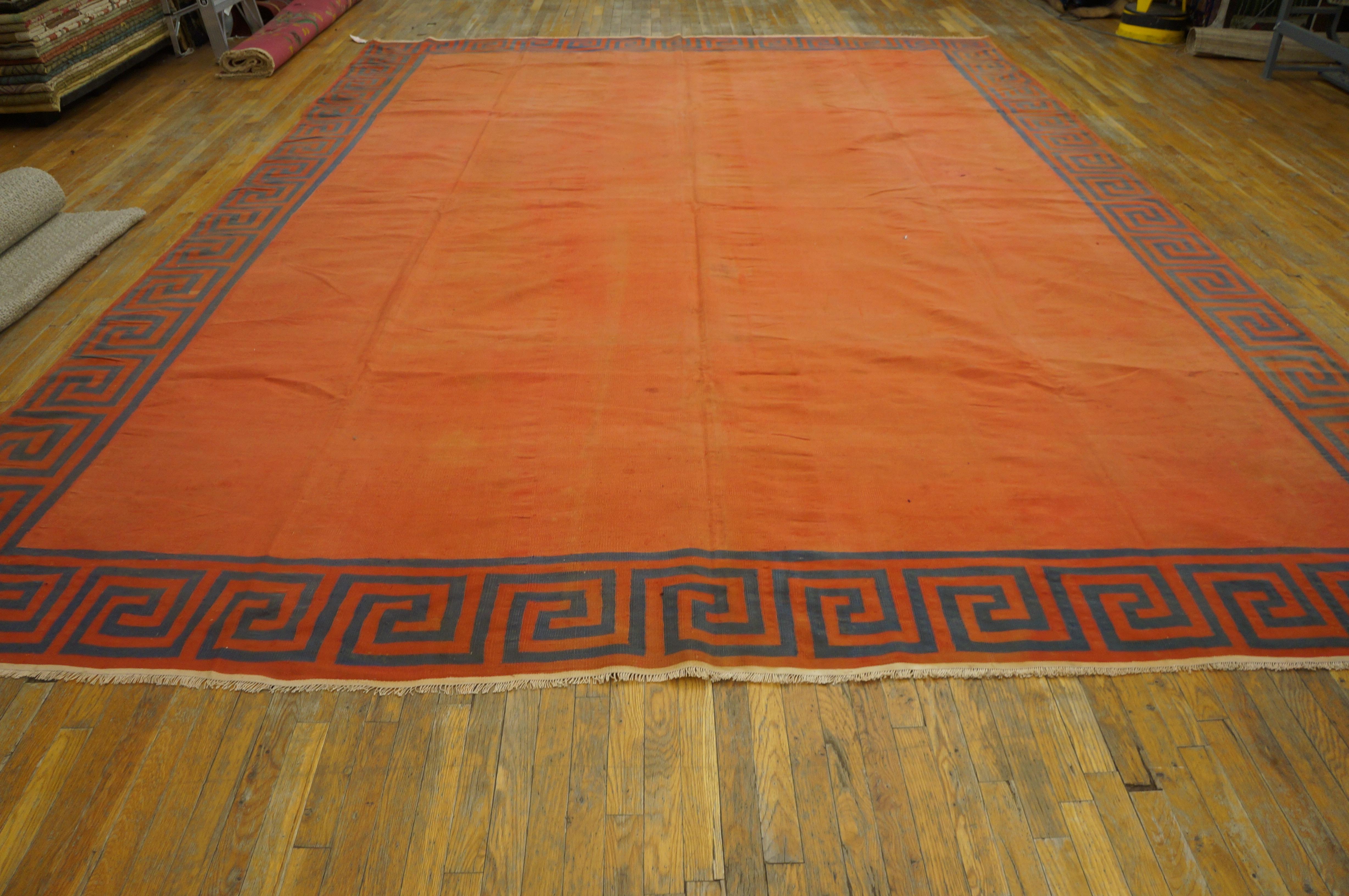The totally plain salmon-orange field is neatly framed by the middle blue and salmon squared wave border. The blue has a light abrash. Good condition for this antique Indian cotton pileless carpet.