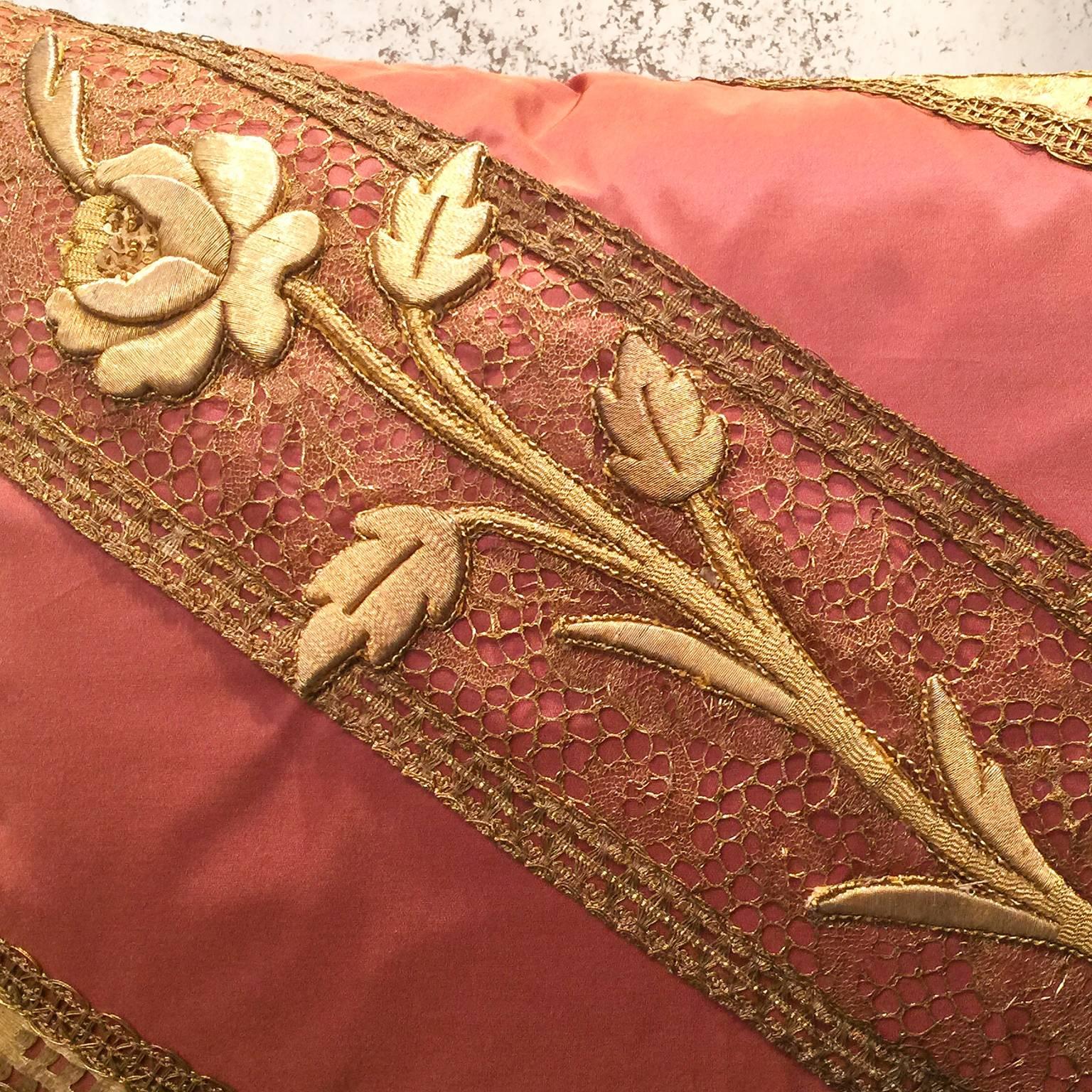 The diagonal decoration is composed by layering of a rare 19th century. French handmade gold lace bordered by 18th century. Italian gold metallic trim with an applique of raised gold metallic embroidery of a rose, stem, and leaves. The composition