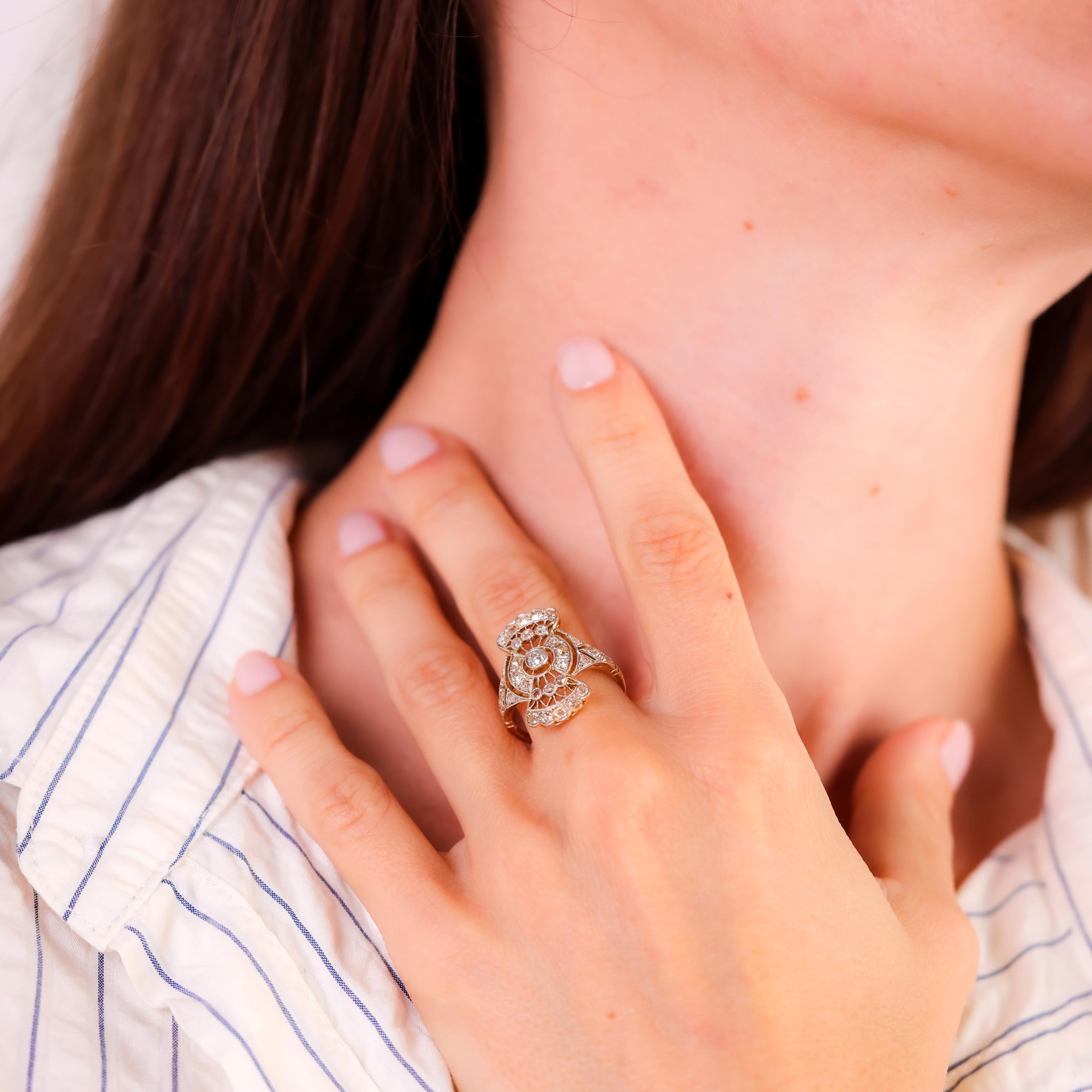 Center Stone: 25 Old Mine Cut and 6 Rose Cut Diamonds
Total Diamond Weight: Approximately 0.8 Carats
Color: I
Clarity: SI-I
Metal: 18K Yellow and White Gold 
Era: Antique 
Circa: 1890's 
Size: 6.75 and can be resized
Gram weight: 4.43 

This