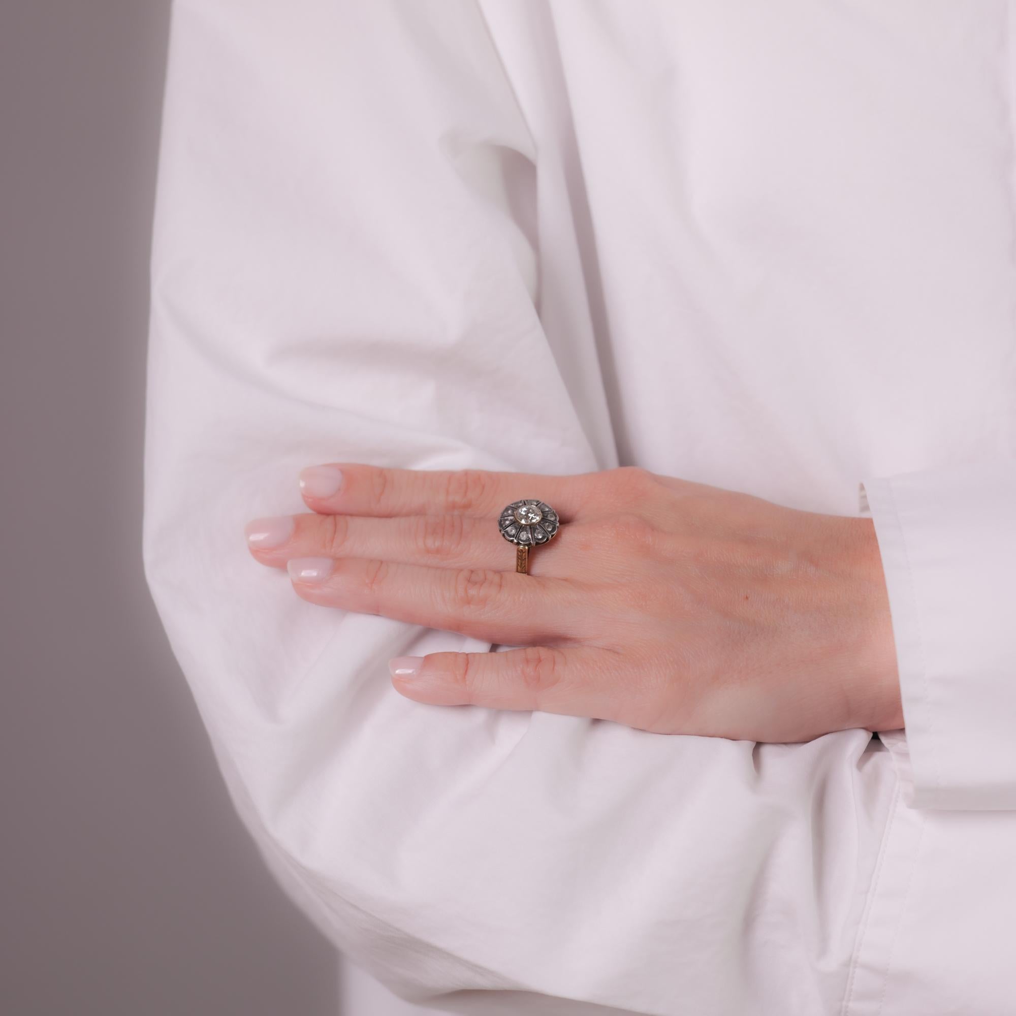 This antique 18k yellow gold and silver ring features an approximately 0.85-carat Old European cut diamond, accented by 10 single-cut greyish diamonds totaling approximately 0.20 carats. Circa 1900s.

Center stone: Old European cut diamond
Weight: