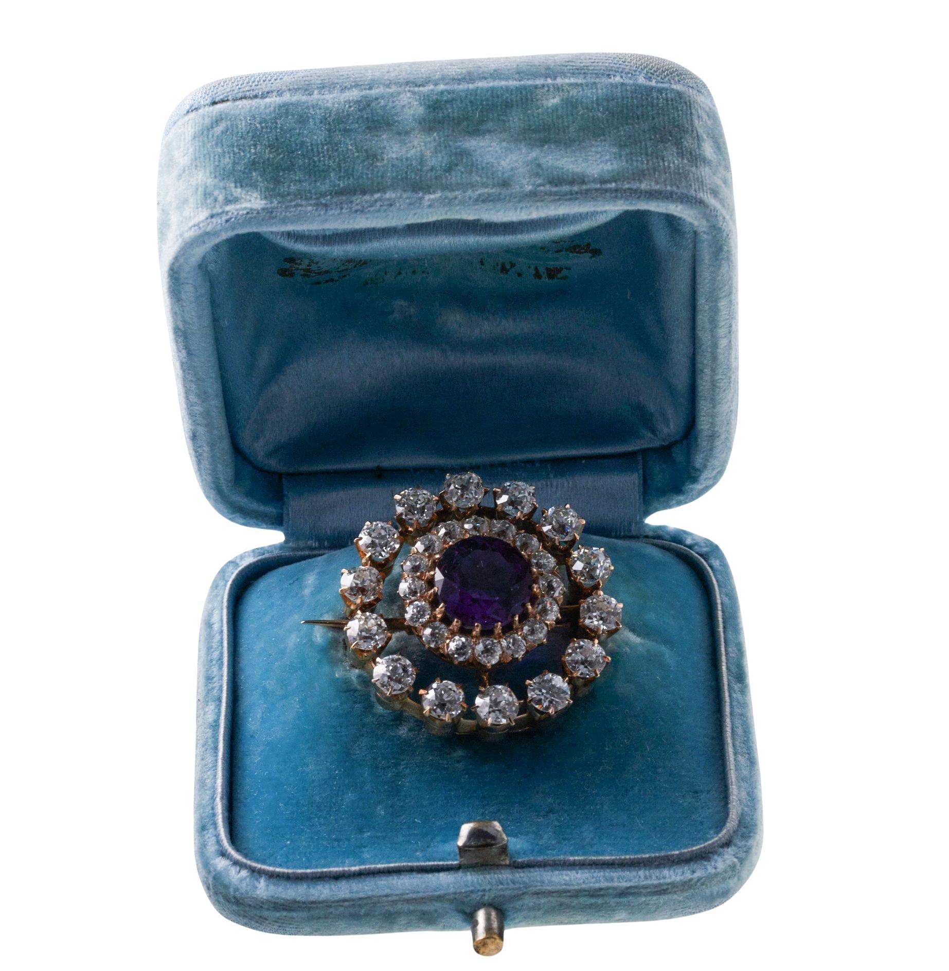 Antique 14k gold brooch, set with center 9.5mm amethyst, surrounded with approx. 3.40ctw diamonds. Brooch comes in original antique fitted box,. the brooch measures 26mm in diameter. Tested 14k. Weight - 9.4 grams. 