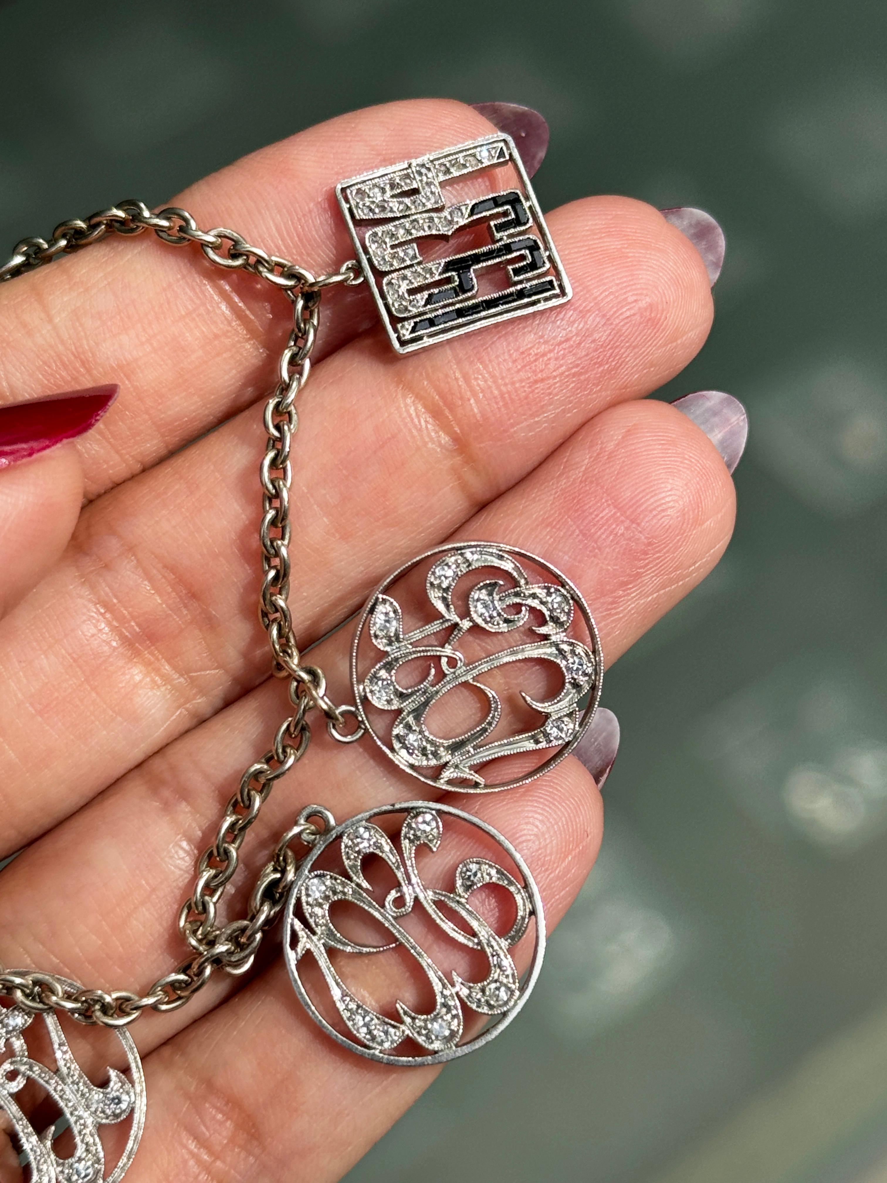 Art Deco Antique Diamond and 14 Carat White Gold and Platinum Multi Charm Bracelet For Sale