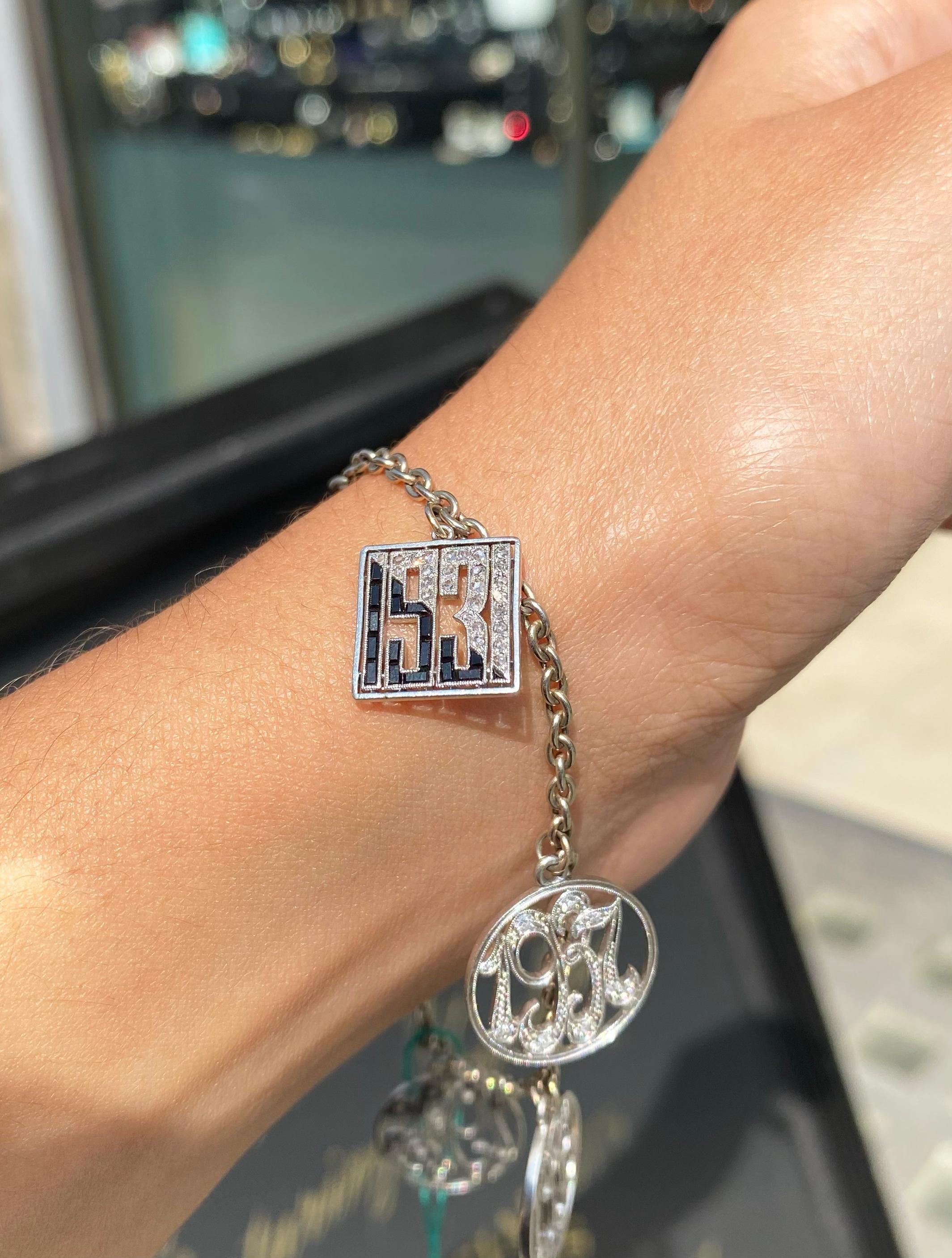 Women's or Men's Antique Diamond and 14 Carat White Gold and Platinum Multi Charm Bracelet For Sale