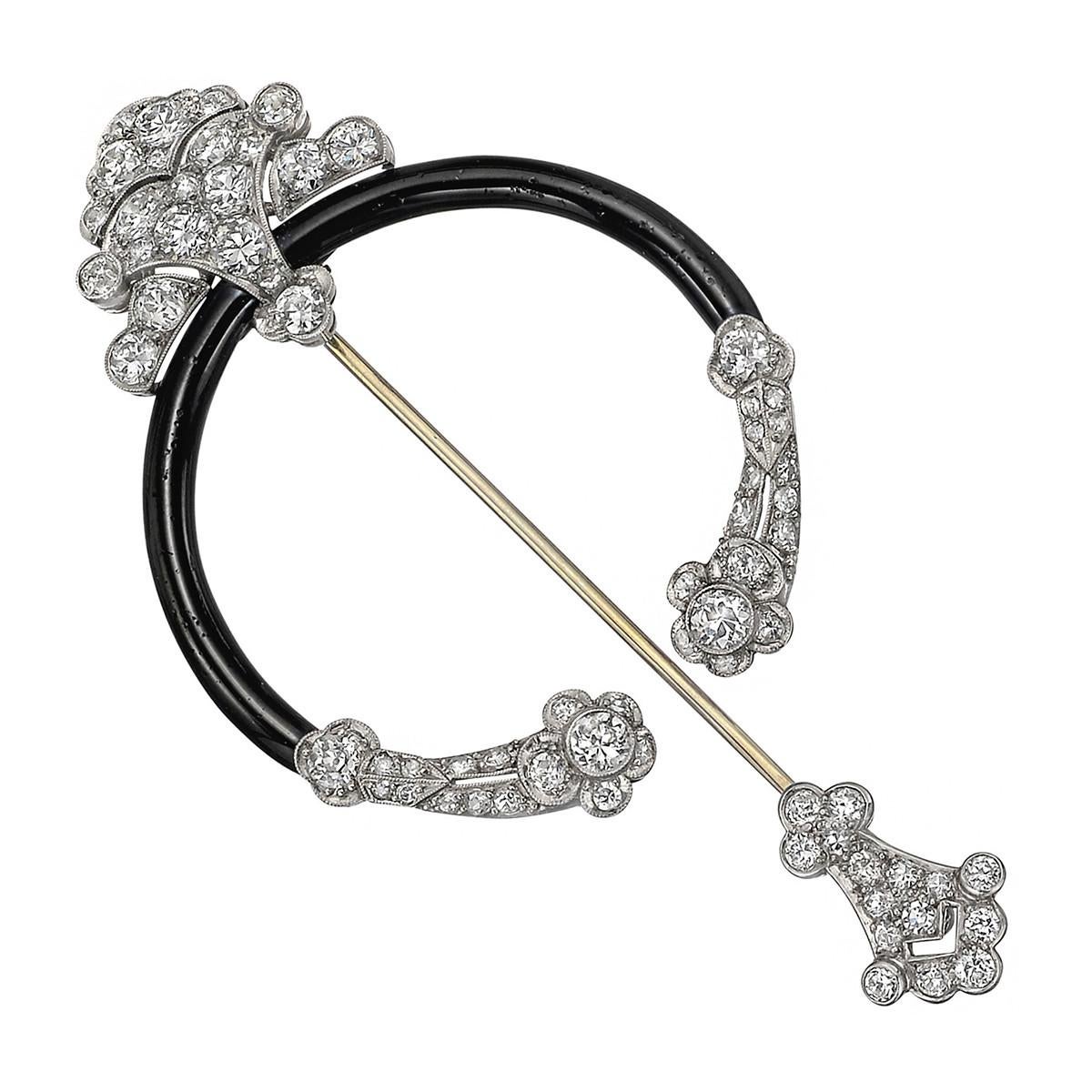 Fibula brooch, featuring old mine-cut diamonds highlighted by black enamel, set in platinum.

70 diamonds weighing ~3.27 total carats
Gold pin stem
3.05