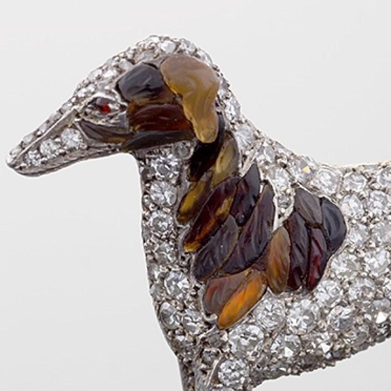An Antique 15 karat gold and silver topped diamond brooch. The body of this Borzoi has 230 pavé rose and Old European-cut diamonds with an approximate total weight of 3.60 carats. The markings are created of intricately carved shades of amber.  
