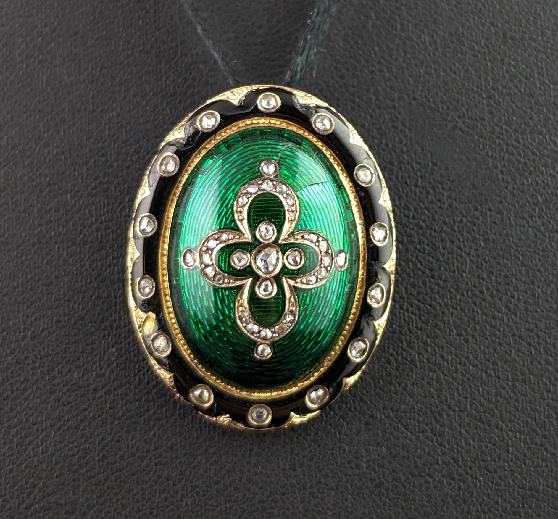 This beautifully crafted Victorian pendant is really something else!

A true beauty which features a combination of rich green guilloche enamel, black enamel and 18ct gold, highlighted by a rose cut diamonds.

The outer edge of the pendant is
