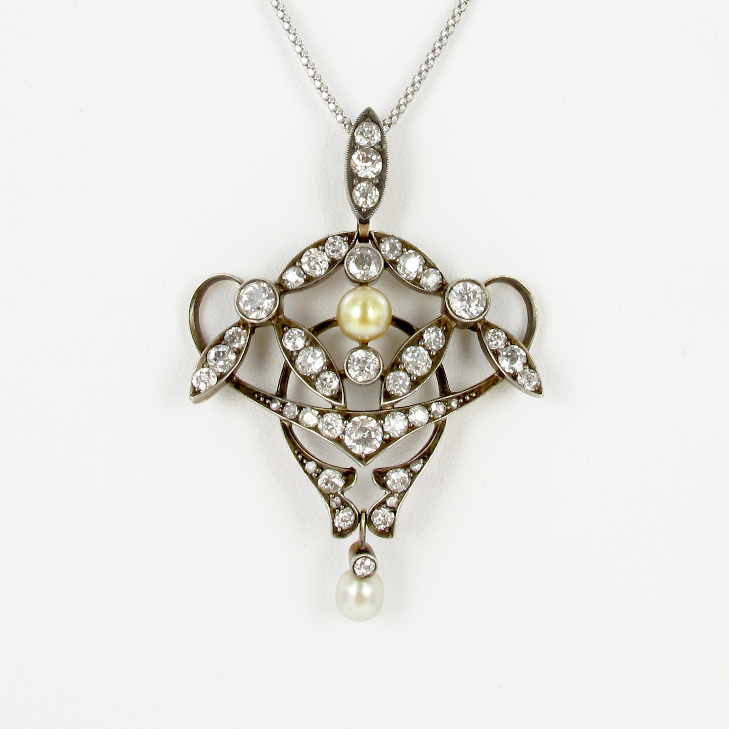 This cute Victorian pendant is held in silver on gold 750 which is a typical combination for that period. The pendant is set with 39 old cut diamonds totaling approximate 3.10 carats. The diamonds are of H/I-vs/si quality. The pendant is further