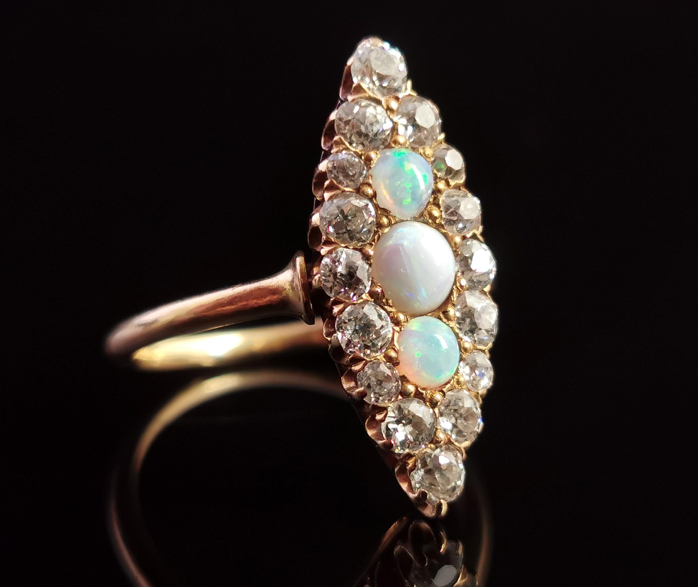 An absolutely stunning antique Opal and diamond navette ring in 18ct yellow gold.

Three beautiful glowing opals set to the centre of the face, the largest in the centre with two smaller ones above and below, they have a beautiful array of colours