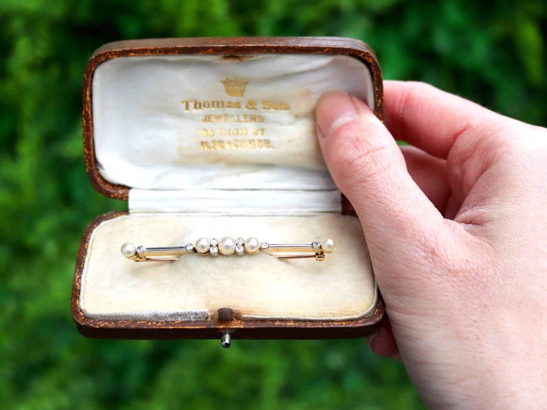 A fine Victorian 0.13 carat diamond and pearl, 9 karat yellow gold and platinum set bar brooch; part of our antique jewelry and estate jewelry collections.

This fine and impressive antique bar brooch has been crafted in 9k yellow gold with a