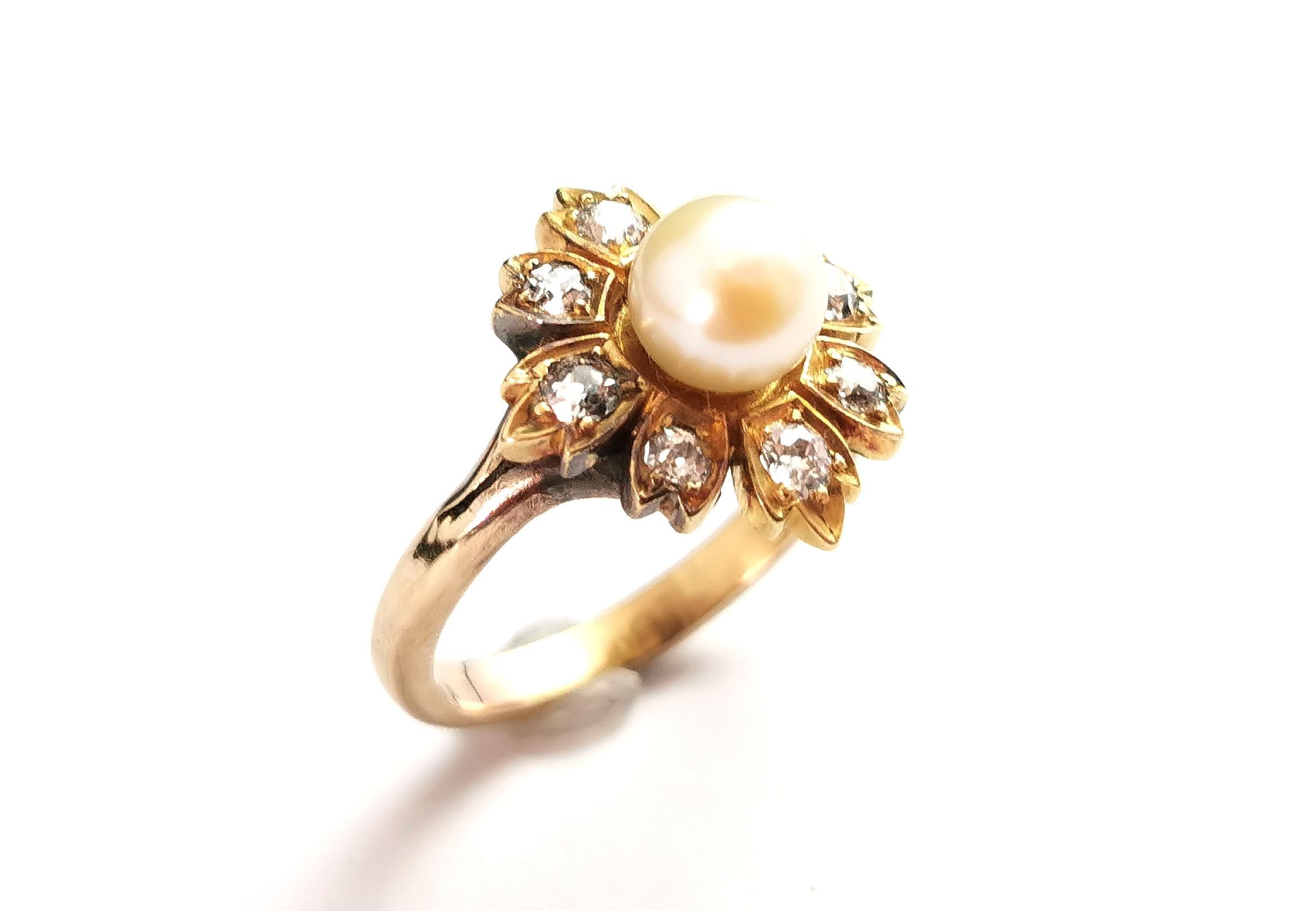 A stunning antique Diamond and pearl flower ring.

A rich 15ct yellow gold flower set with eight sparkling old mine cut diamonds to each petal, approx 0.30ct in total.

It has a lovely single creamy pearl set to the centre of the flower.

Such a