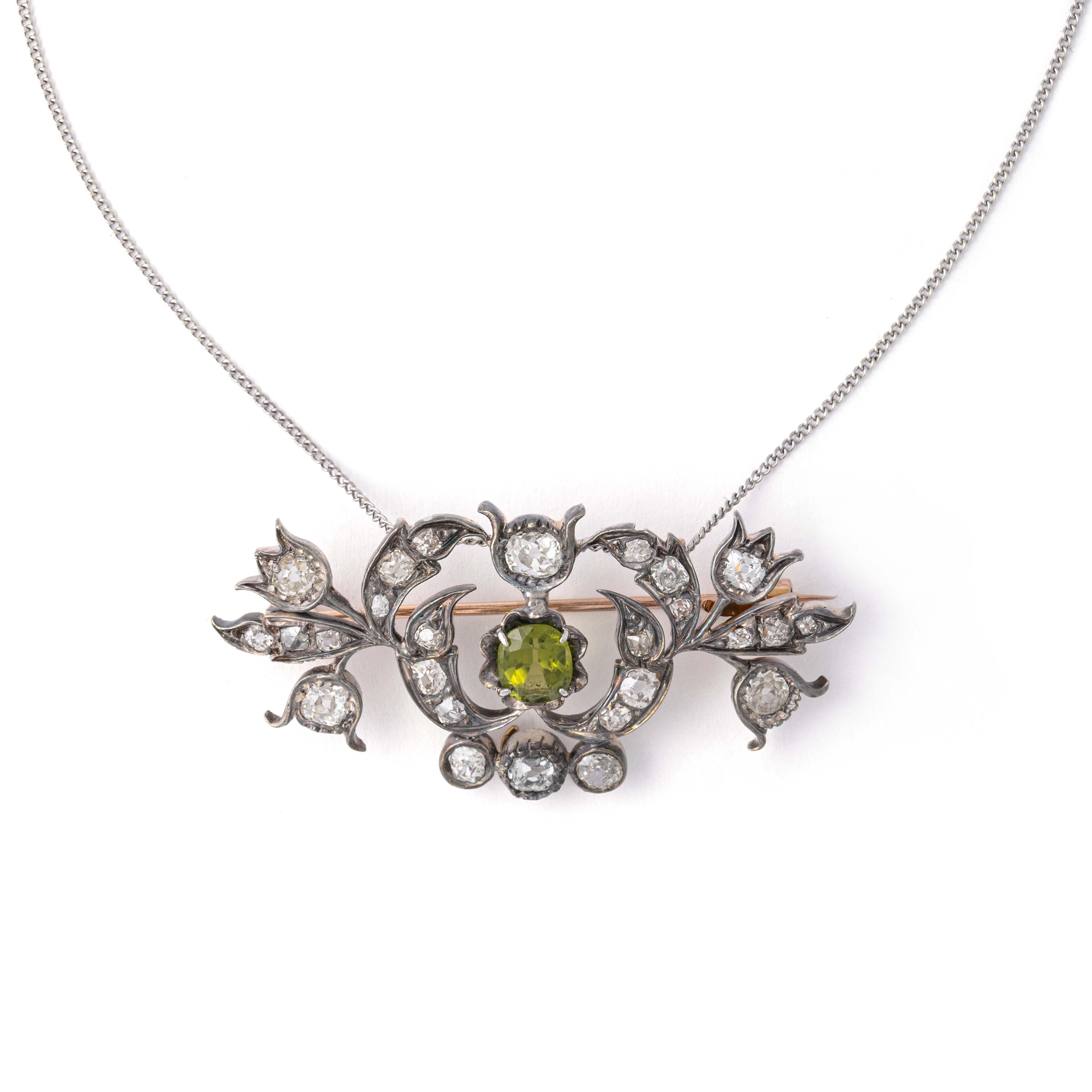 Antique Old mine cut Diamond and cushion old mine cut Peridot on silver and gold Brooch convertible Pendant.
The Pear shape old mine cut Diamond can be detached and worn as a separate pendant. 
The pear shape Diamond is estimated to weight in our