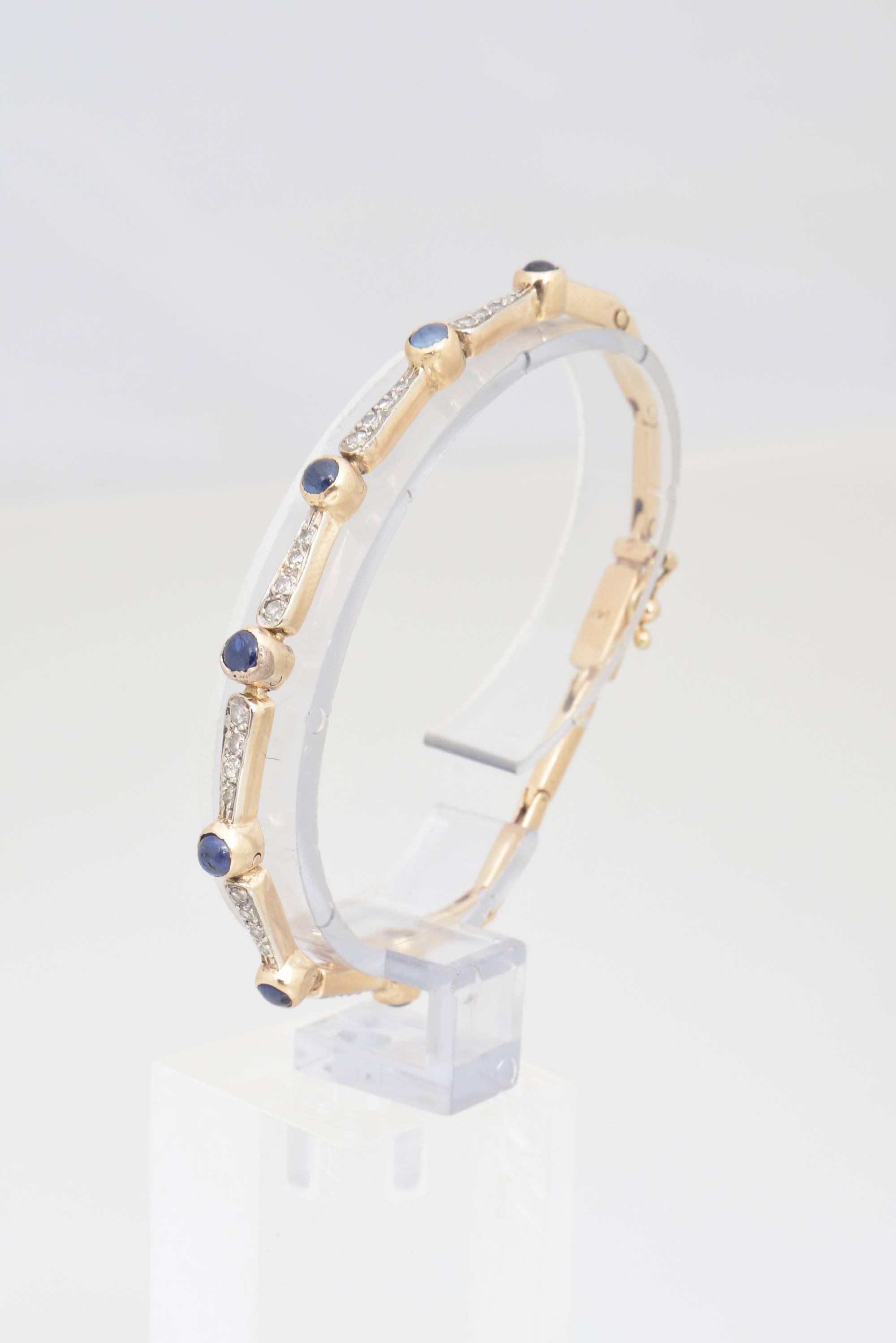 Antique delicate 14K yellow gold bracelet featuring seven bezel-set cabochon sapphires between six diamond bars. Marked on clasp.