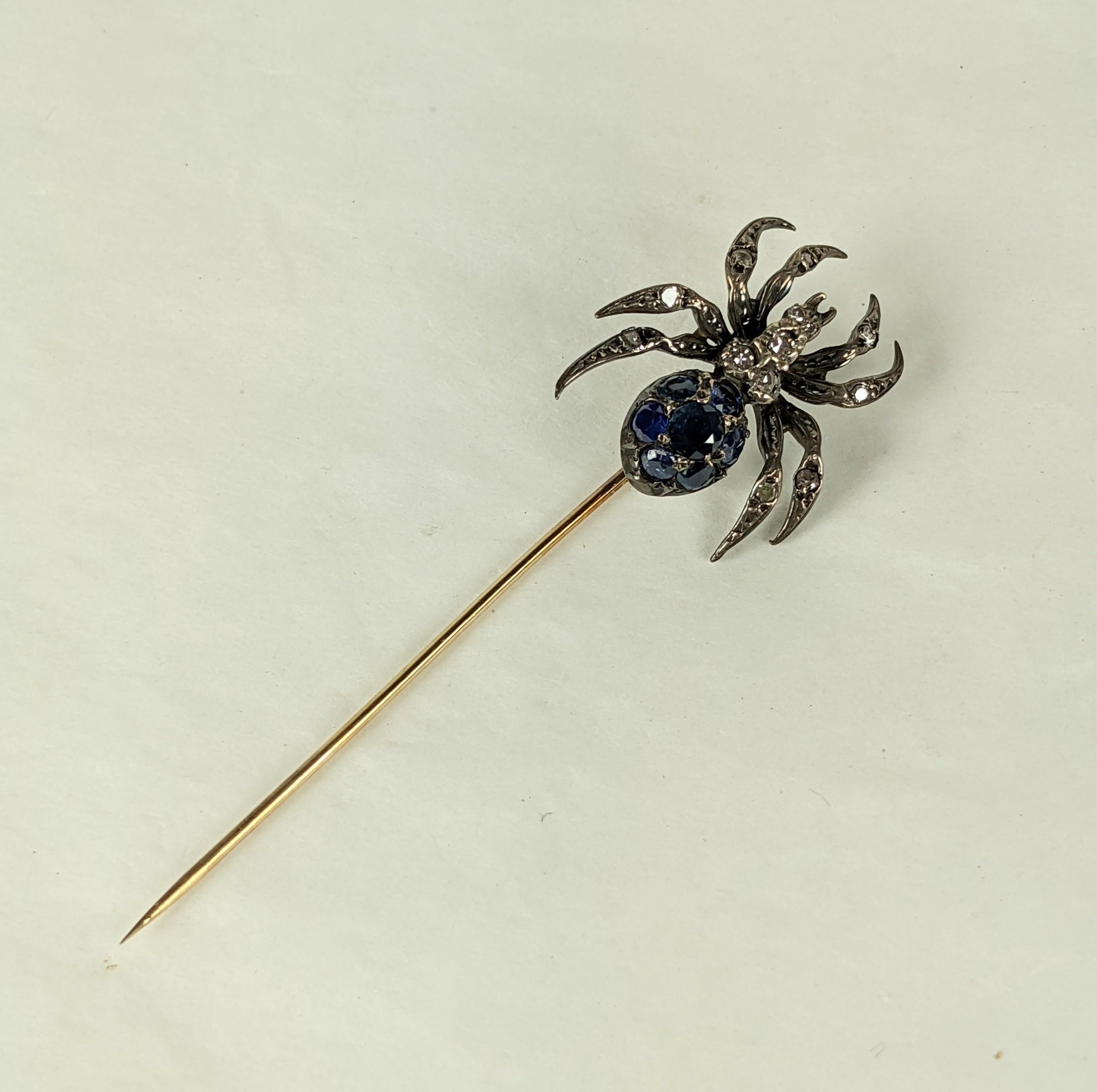 Striking Antique Diamond and Sapphire Spider Stickpin from the turn of the 20th Century. Beautifully detailed, set in silver topped gold with round diamonds and a pave sapphire body with 14k gold shaft. 
1890-1900. 
