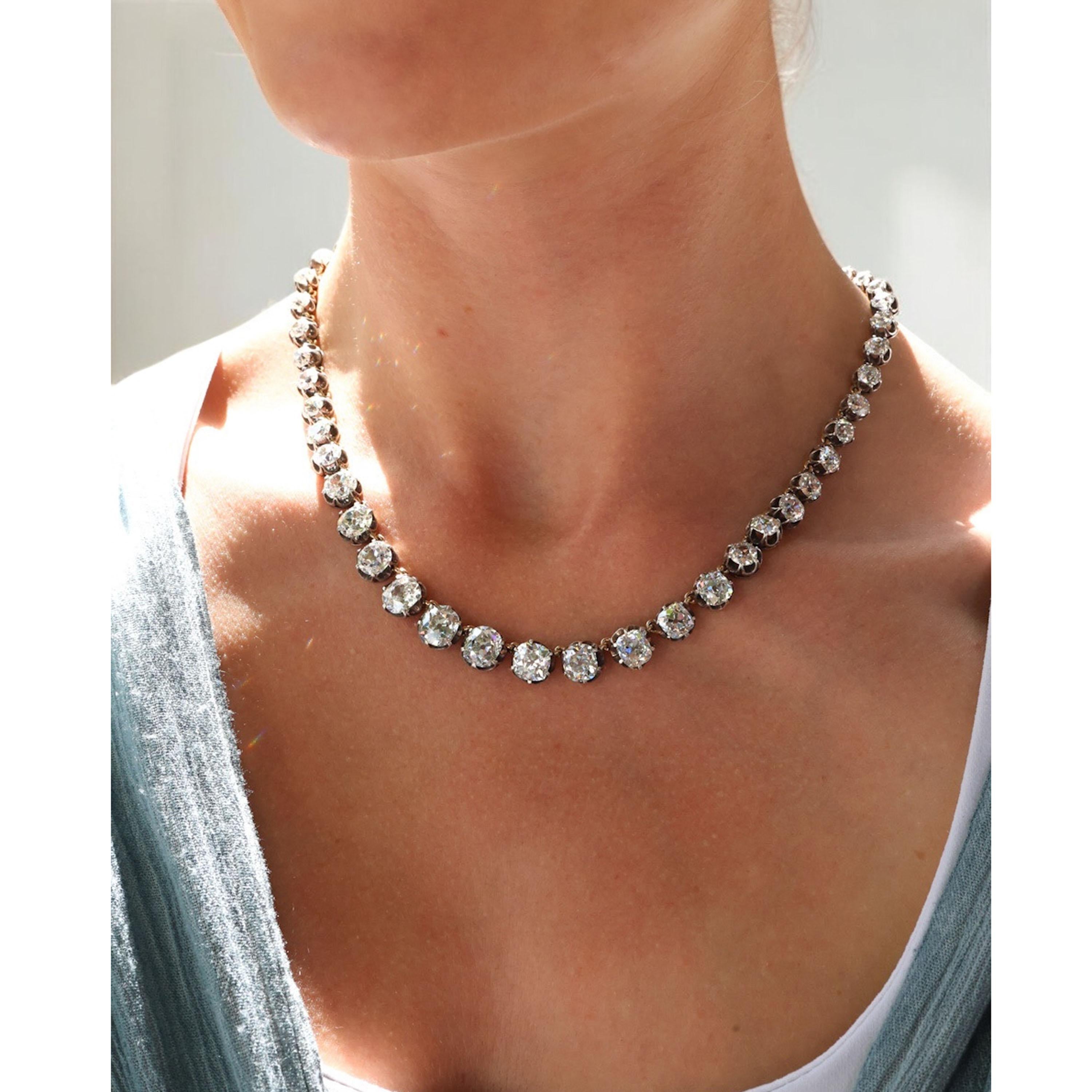 An antique diamond riviére necklace, featuring 54, old-cut diamonds, in silver-upon-gold crown claw settings, with gold links, on a diamond set box and tongue clasp, with a figure-of-eight safety catch, circa 1880. Estimated total weight of