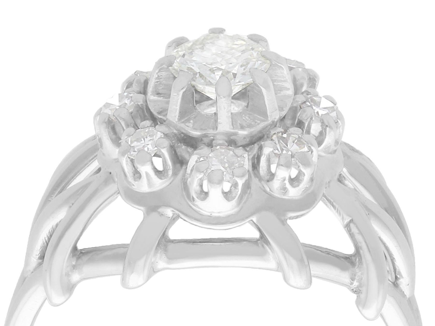 A stunning, fine and impressive 0.73 carat diamond, 15 karat white gold and platinum set cluster ring; part of our diverse antique jewelry and estate jewelry collections

This stunning, fine and impressive antique cluster ring has been crafted in