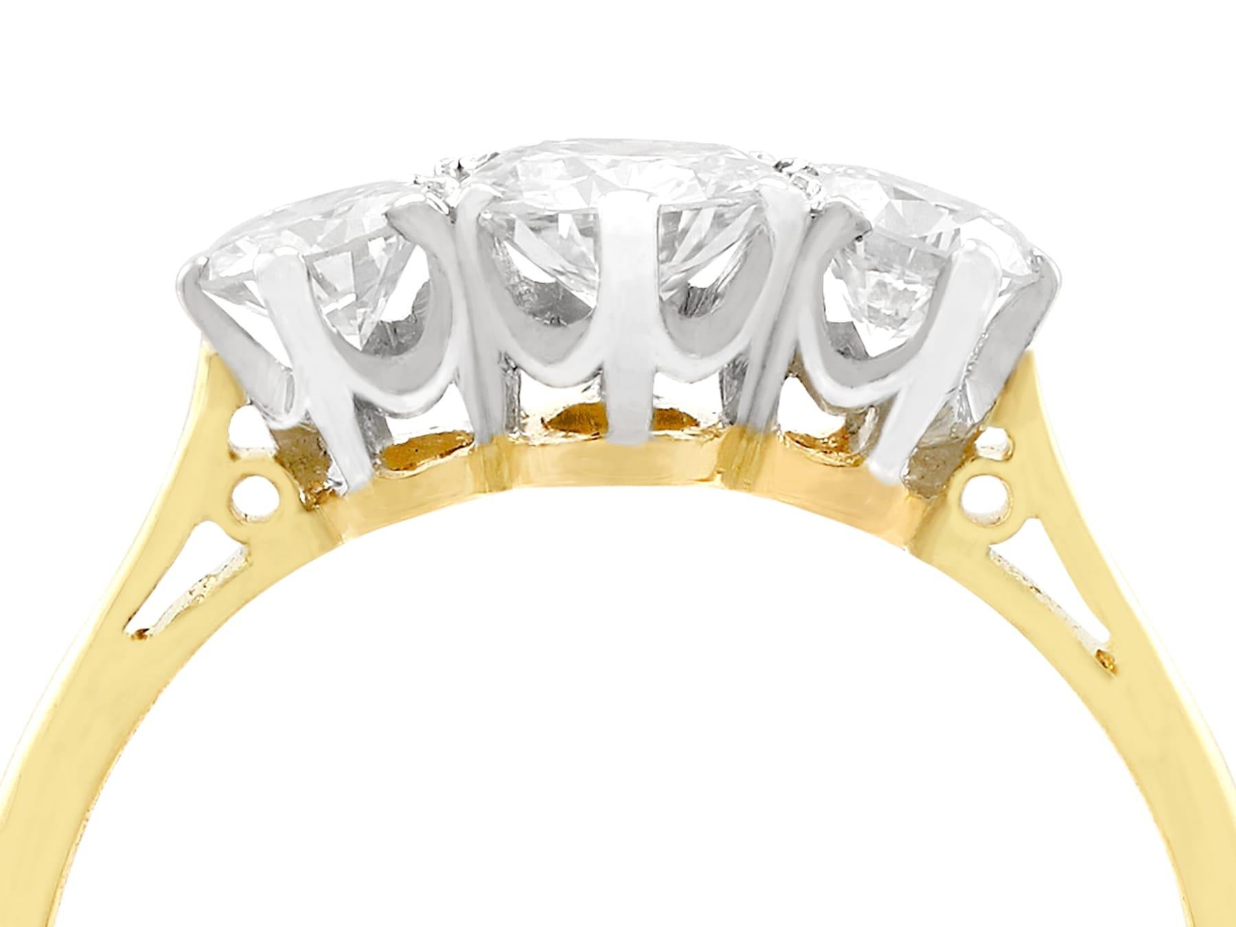 An impressive antique 1930s 0.75 carat diamond and 18 karat yellow gold, platinum set trilogy ring; part of our diverse antique jewelry collections.

This fine and impressive three stone diamond ring has been crafted in 18k yellow gold with a