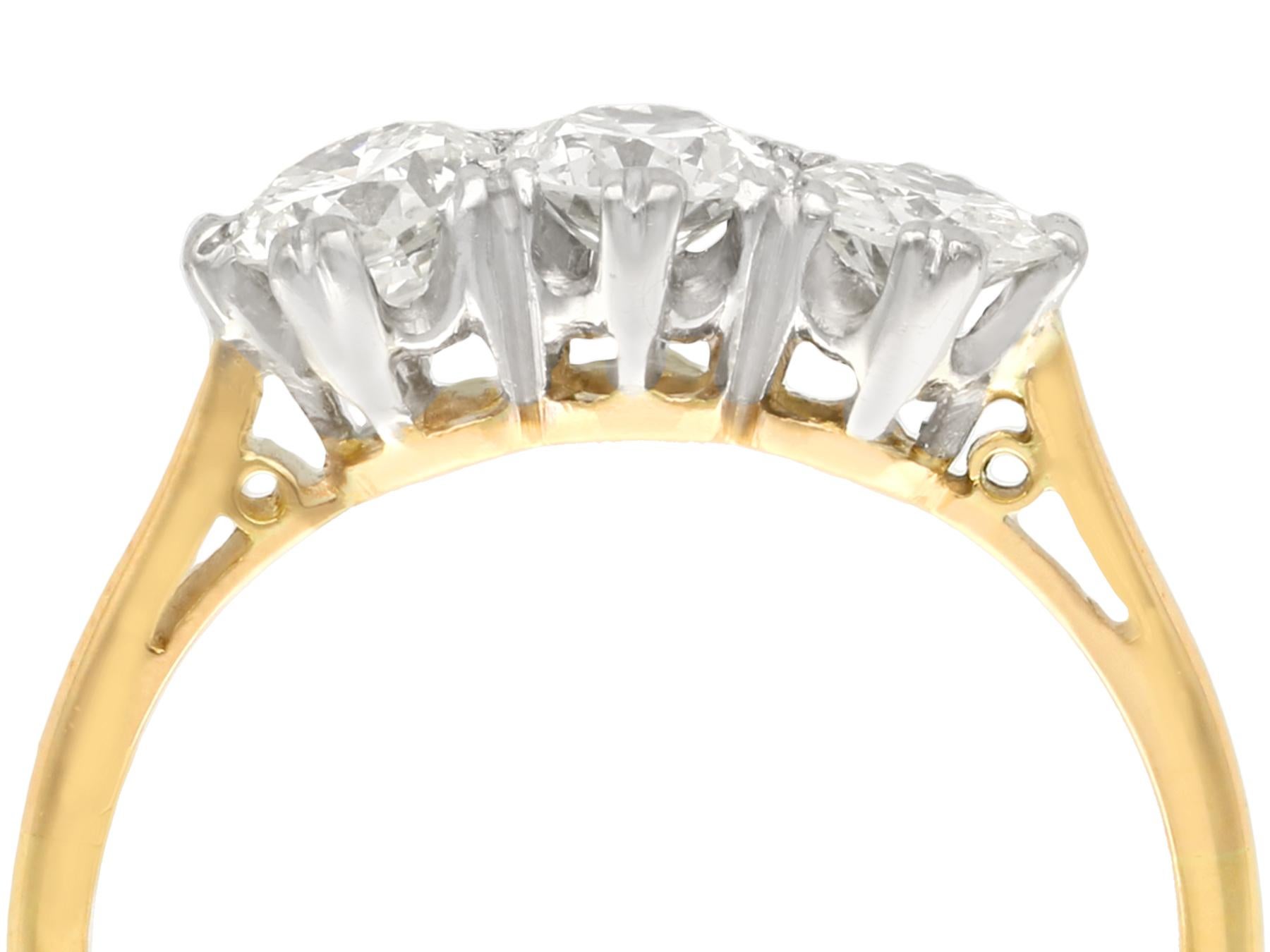 An impressive vintage 0.93 carat diamond and 18 karat yellow gold, 18 karat white gold set trilogy ring; part of our diverse antique jewelry and estate jewelry collections.

This fine and impressive gold diamond trilogy ring has been crafted in 18k