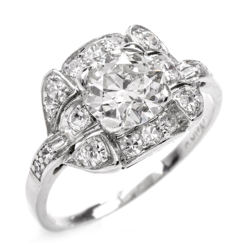 This classic Art Deco diamond ring is crafted in solid platinum. Exposing a European round-cut diamond weighing approx. 1.25 carats, graded H-I color, and extremely nice SI1 clarity, small feather on the side. Pave-set with 22 diamonds weighing