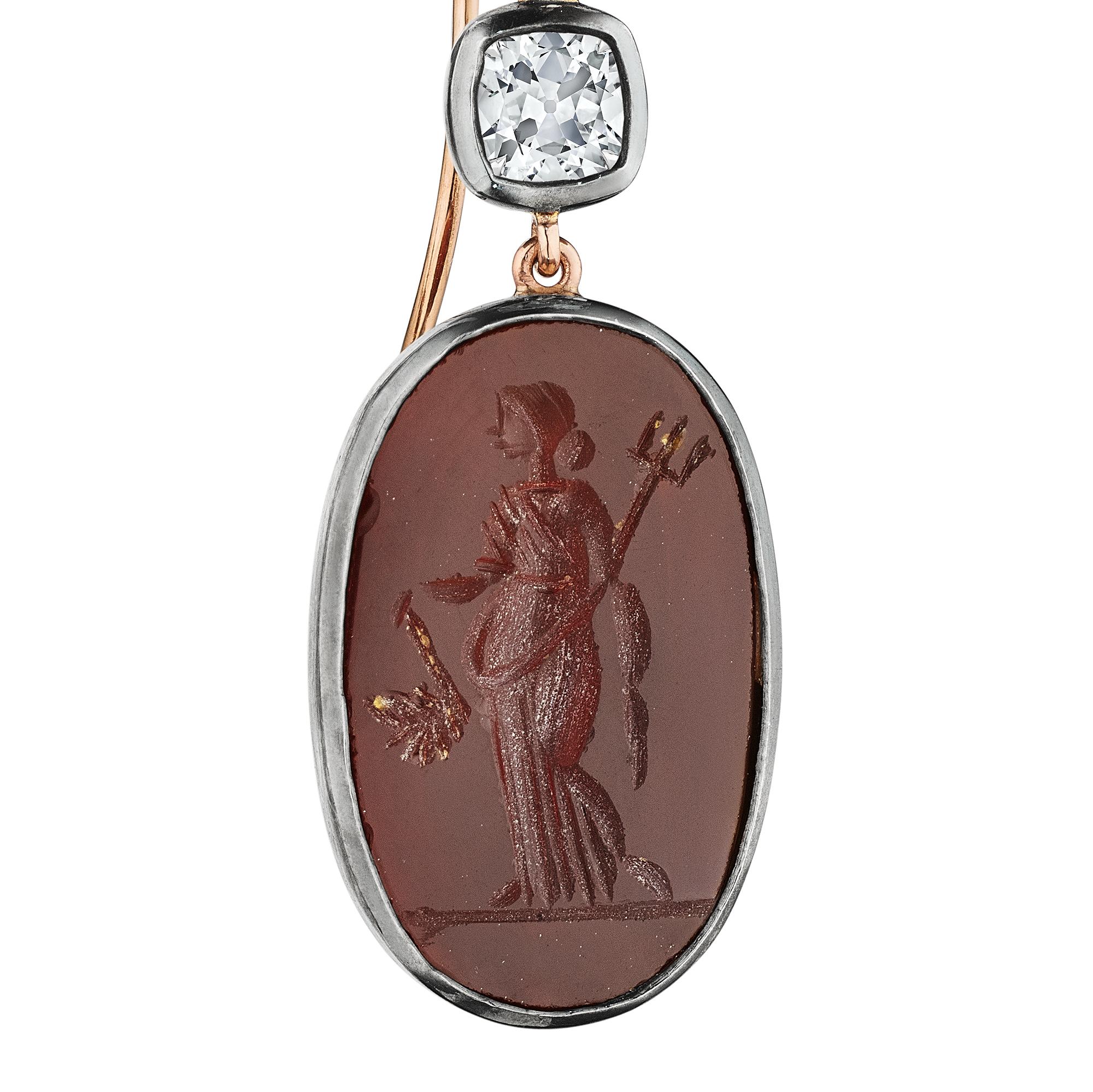 These oval cut antique carnelian intaglio hardstone earrings feature the statuesque silhouettes of a warrior man and woman dressed in ancient garb and magically topped with bezel set cushion cut diamonds.  Hanging seductively from a 18 karat rose