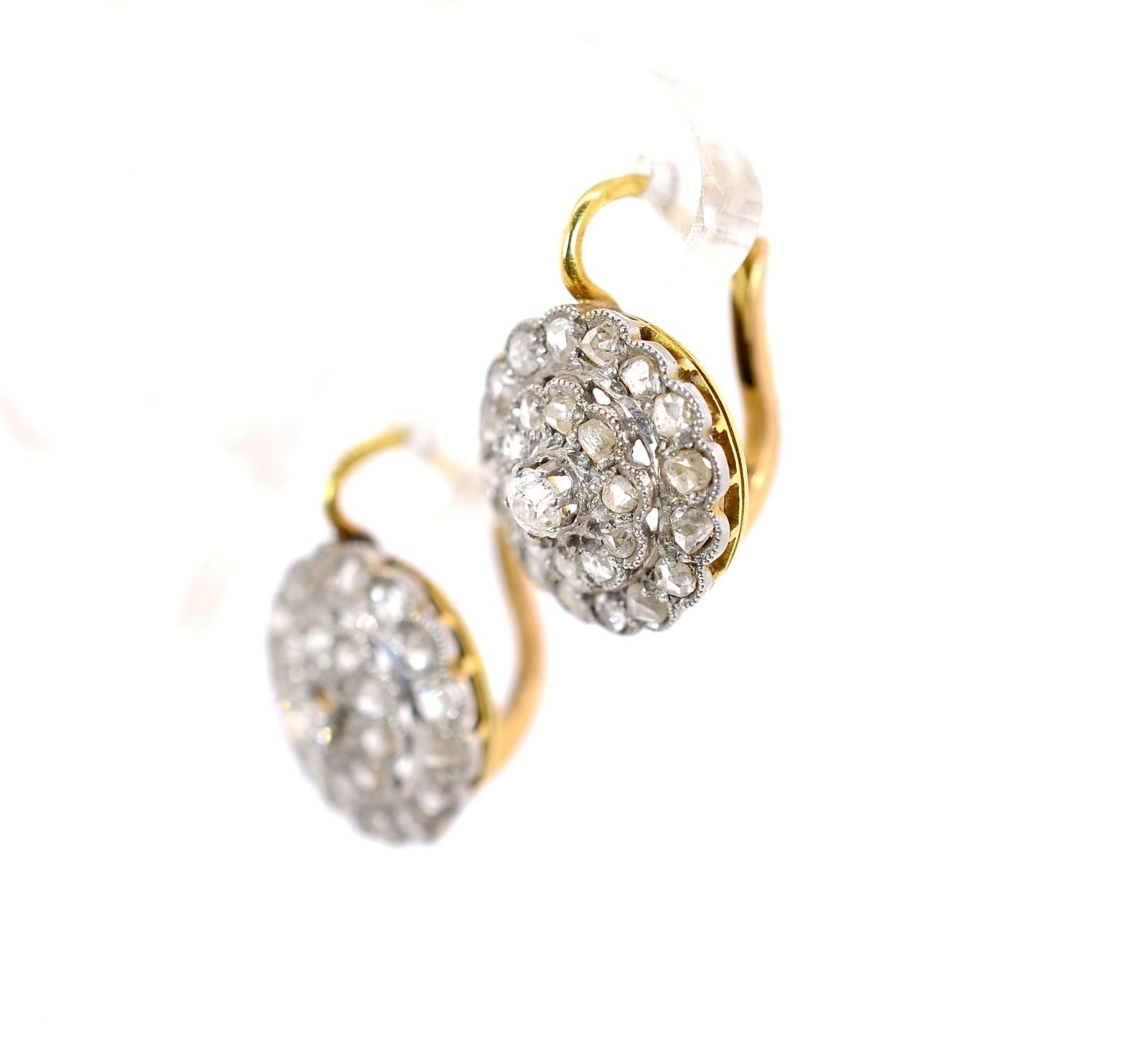 Handcrafted in the 1920s these lovely cluster earrings are a find!  The earrings are platinum-topped 18KT yellow gold,  and each centers an Old cut Diamond surrounded by sparkly Rose cut Diamonds.  The diamonds weigh a total of approx. 1.50 carat of