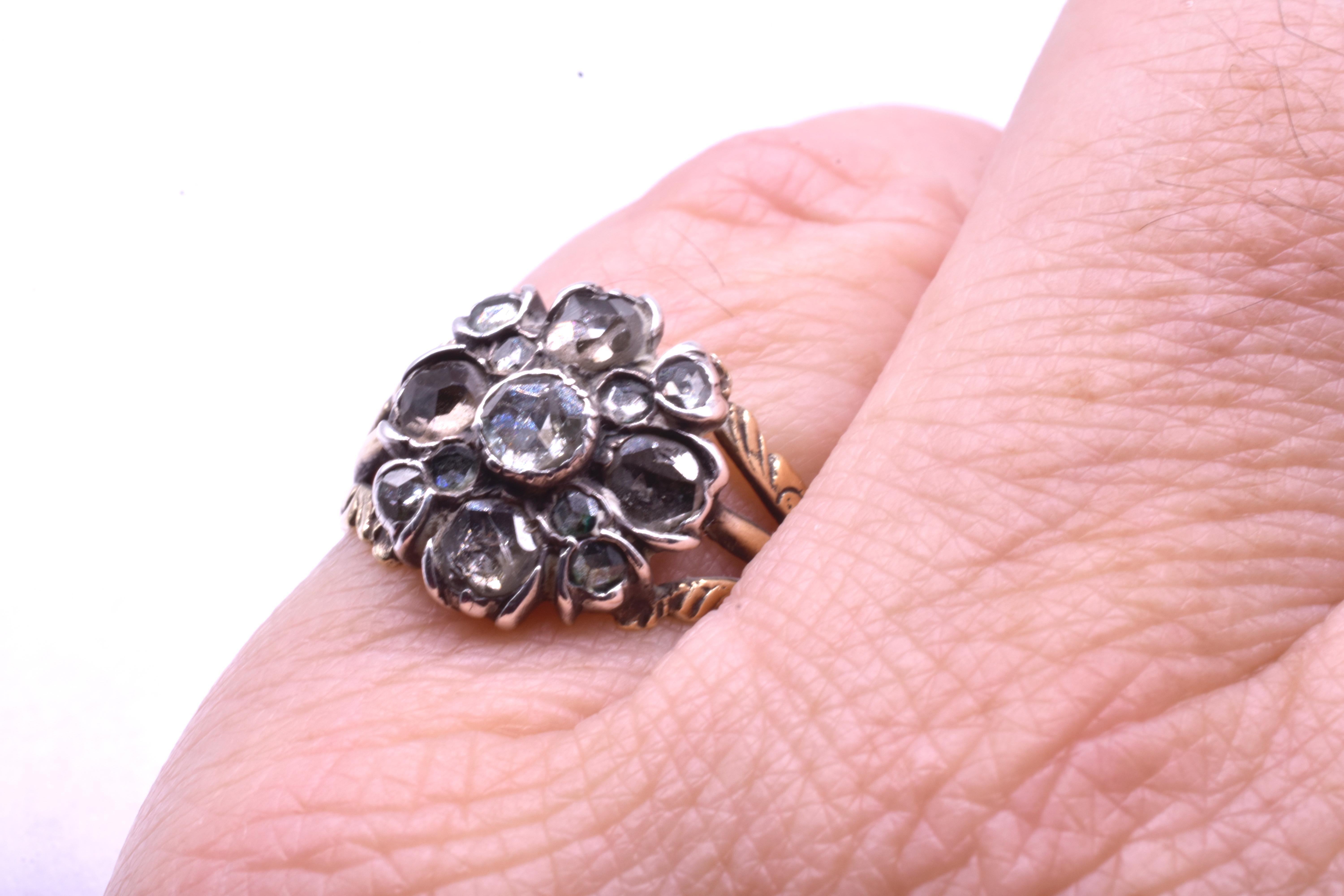 Early Georgian rose diamond cluster ring set in silver with an 18K gold embossed band. Rings of this period are very scarce and hard to find in such wonderful condition. This is a real collector's piece. The ring is size 6 and can be sized to fit.