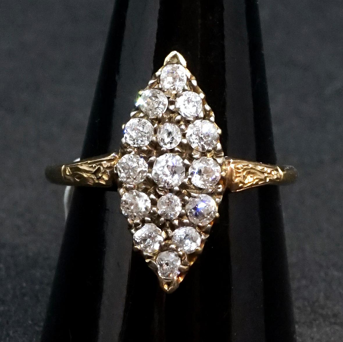 Antique navette-shaped old brilliant-cut diamond ring, fifteen old brilliant-cut diamonds in a cluster, all diamonds estimated to weigh a total of 1.2 carats, claw set in a rose gold mount with engraved shoulders.
 
Austria, circa 1890

head