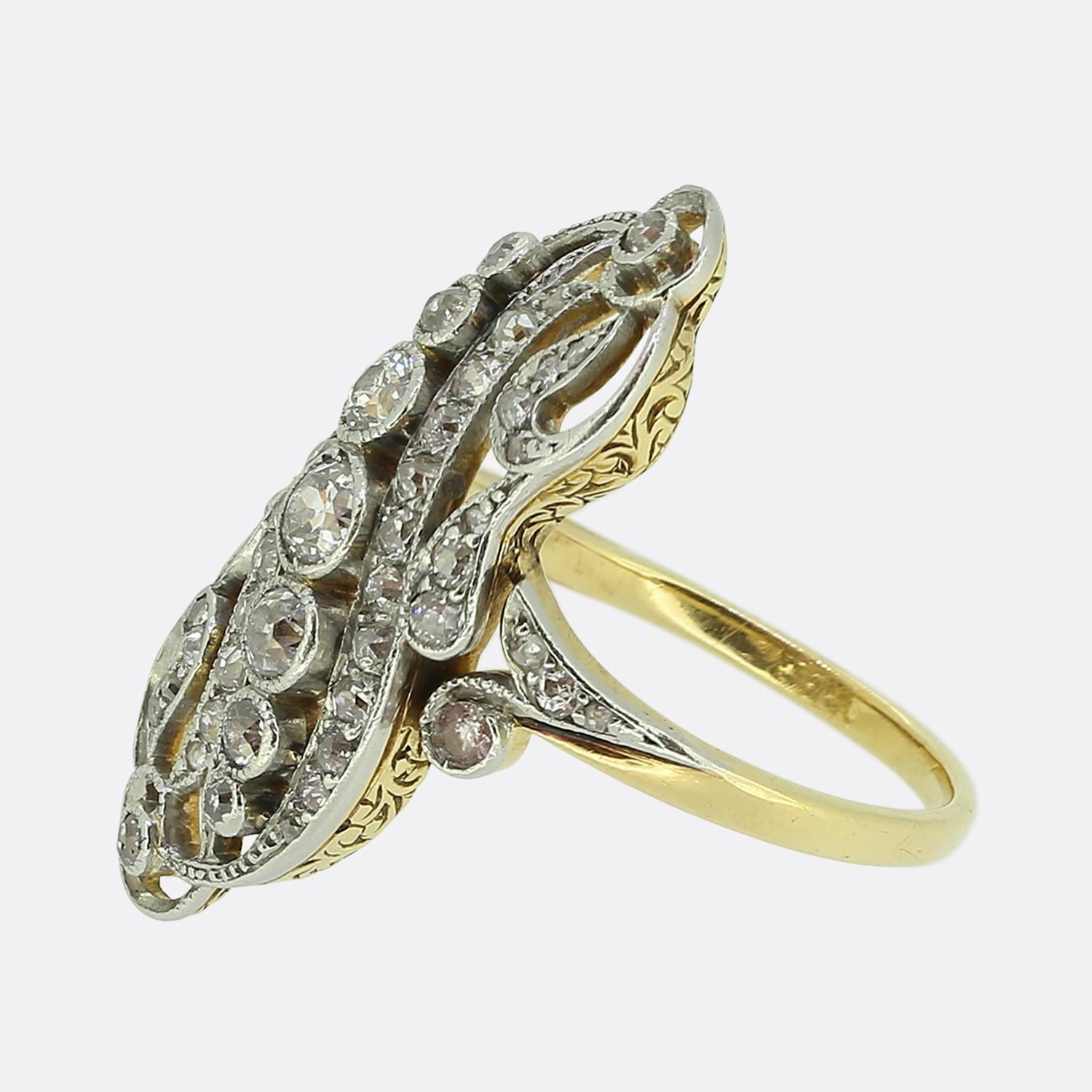 Here we have a stunning diamond dress ring taken from the Edwardian period. This antique piece has been crafted from a warm 18ct yellow gold and showcases an open curvaceous framed filled with multiple rows of round faceted old cut diamonds; all of