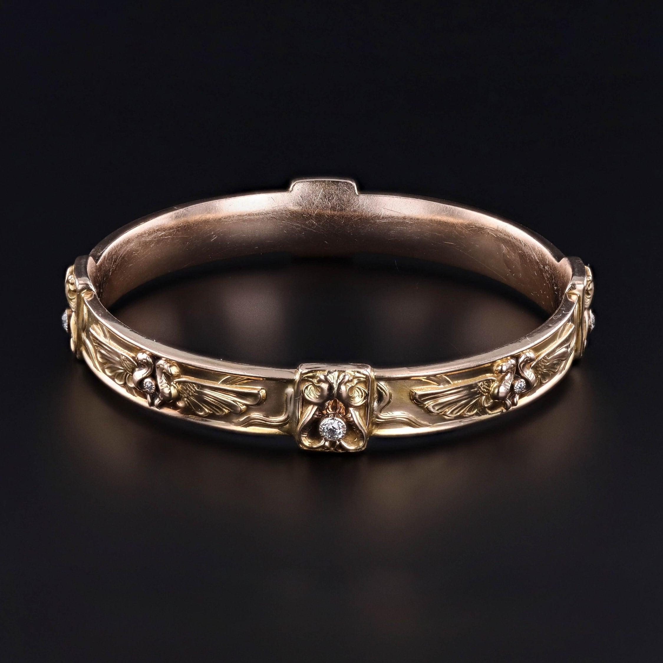 Antique Egyptian Revival Gold Bangle: An alluring antique bangle depicting the Egyptian winged sun disk-- an ancient symbol of protection and divinity. This 14k gold bangle dates to the early 1900s (circa 1900-1910). It is accented with birds and